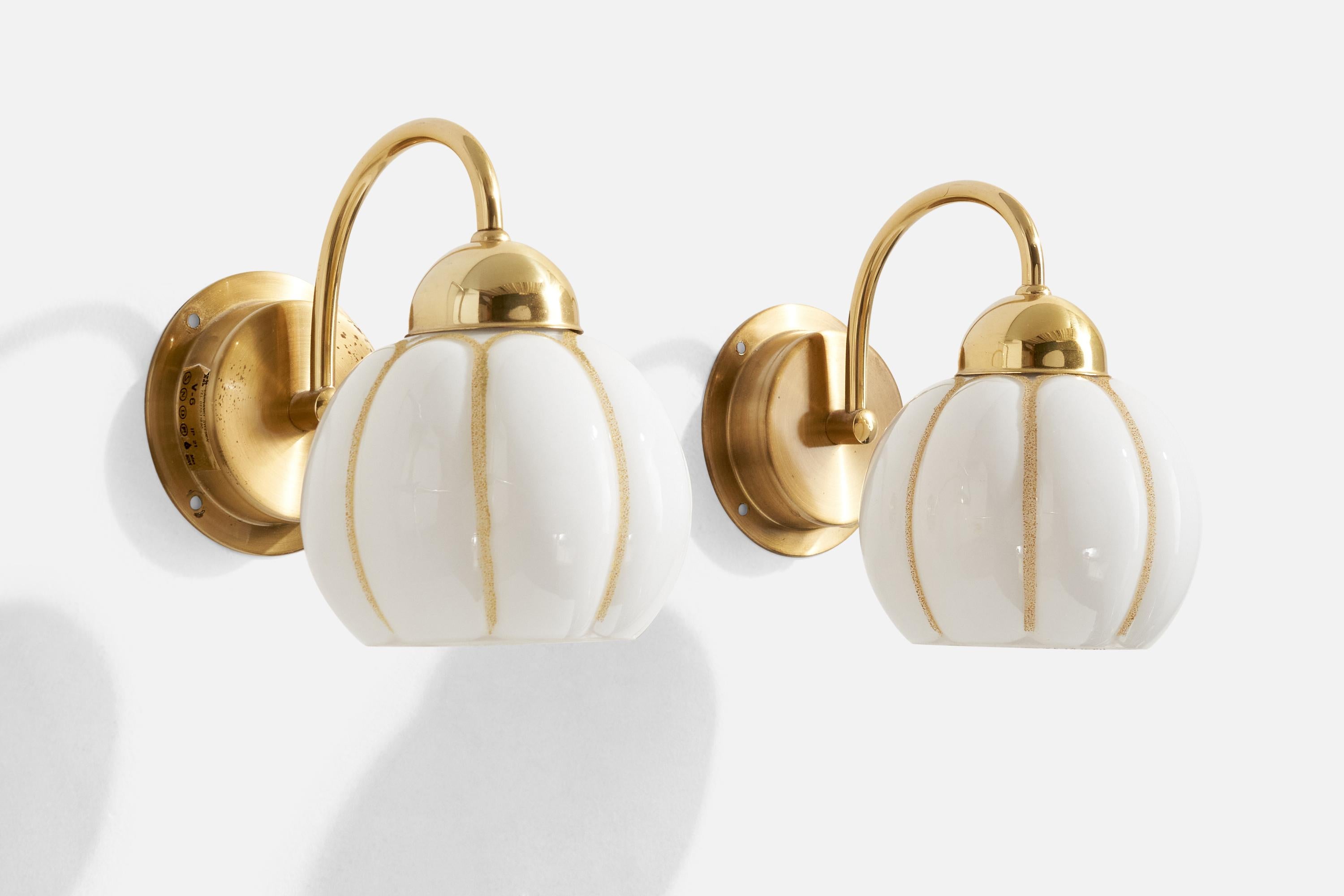 A pair of brass and glass wall lights produced by EWÅ Värnamo, Sweden, c. 1970s.

Overall Dimensions (Inches): 7.6” H x 5.75” W x 7.7“ D

Back Plate Dimensions (Inches): 4.25” H x 4.25” W x 1.1” D

Bulb Specifications: E-26

Number of Sockets (per