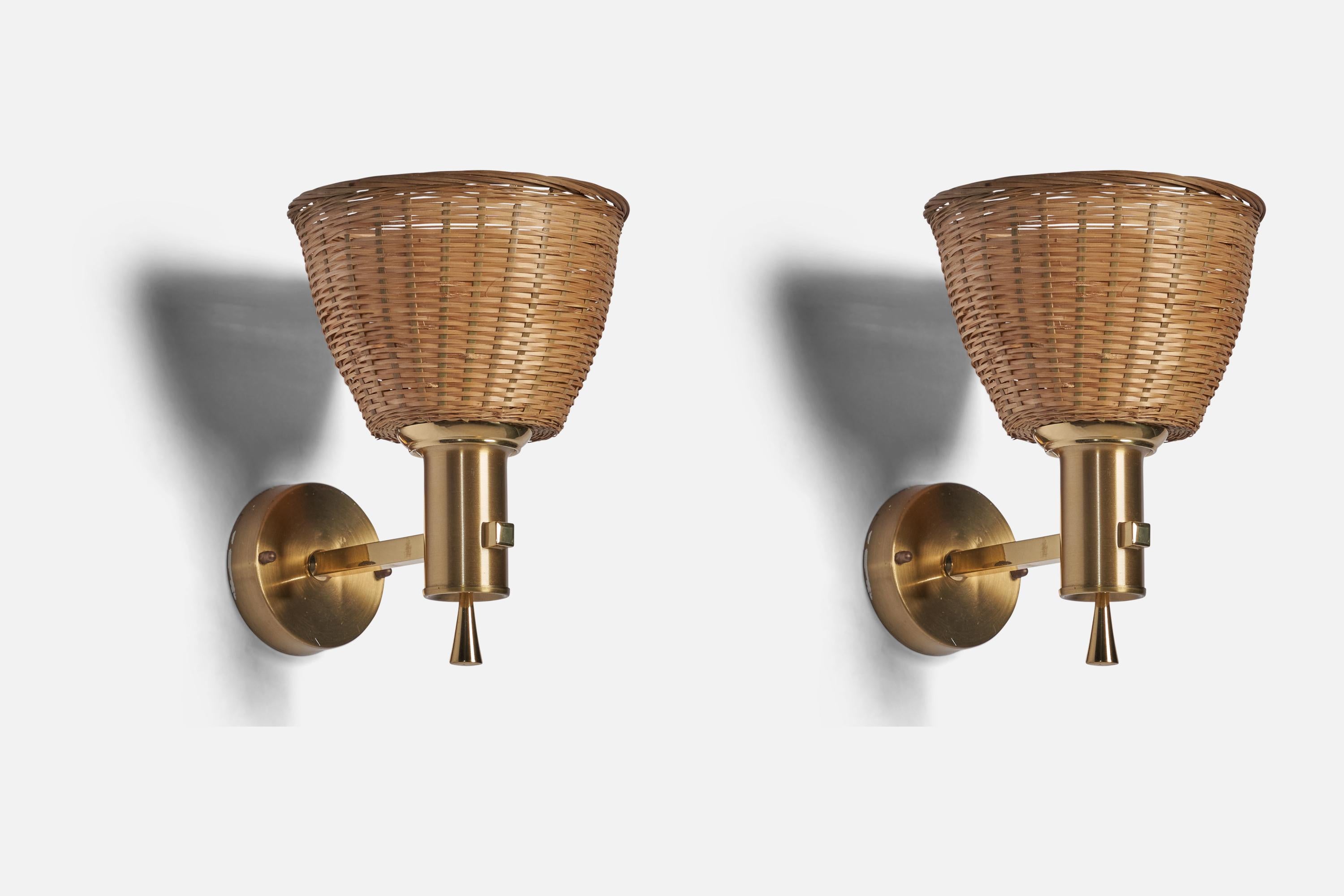 A pair of brass and rattan wall lights designed and produced by Ewå Värnamo, Sweden, c. 1960s.

Overall Dimensions (inches): 9” H x 6.75” W x 9” D
Back Plate Dimensions (inches): 3.5” Diameter
Bulb Specifications: E-26 Bulb
Number of Sockets: 1
All
