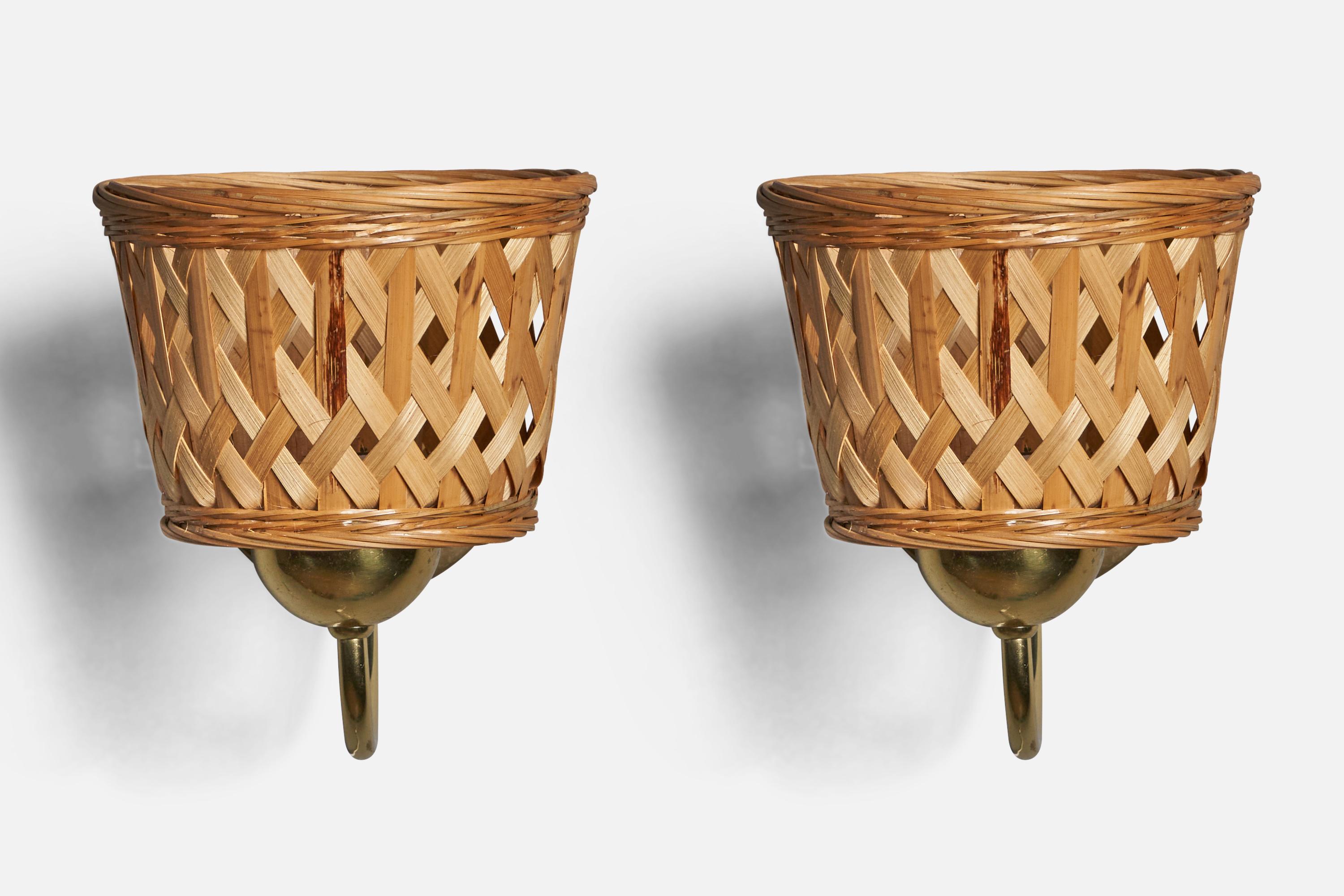 A pair of brass and rattan wall lights, designed and produced by EWÅ Värnamo, Sweden, c. 1970s.

Overall Dimensions: 7.25