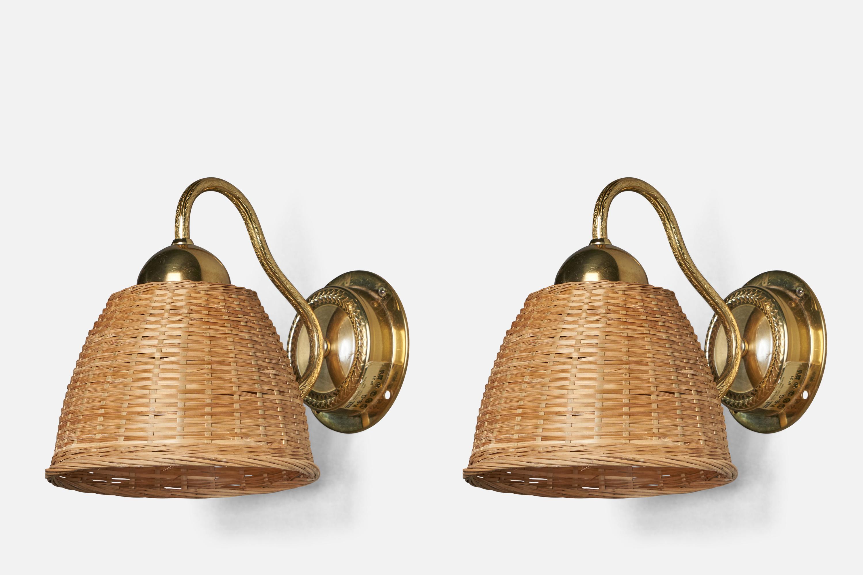 A pair of brass and rattan wall lights, designed and produced by EWÅ Värnamo, Sweden, 1970s.

Overall Dimensions (inches): 7.75