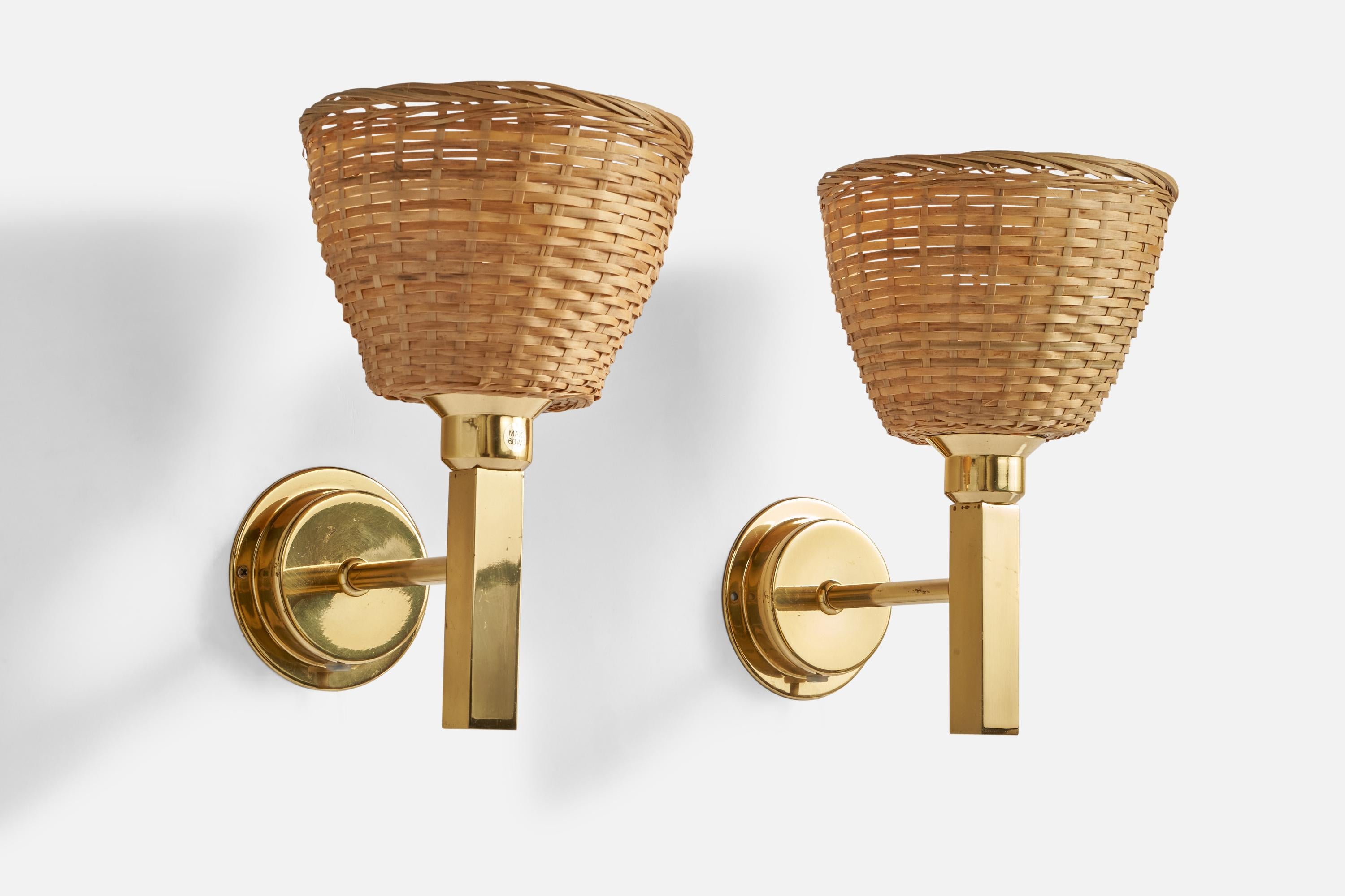 A pair of brass and rattan wall lights designed and produced by Ewå Värnamo, Sweden, 1970s.

Overall Dimensions (inches): 10.5” H x 7” W x 8.5” D
Back Plate Dimensions (inches): 4.25” Diameter x 0.96” Depth
Bulb Specifications: E-26 Bulbs
Number of