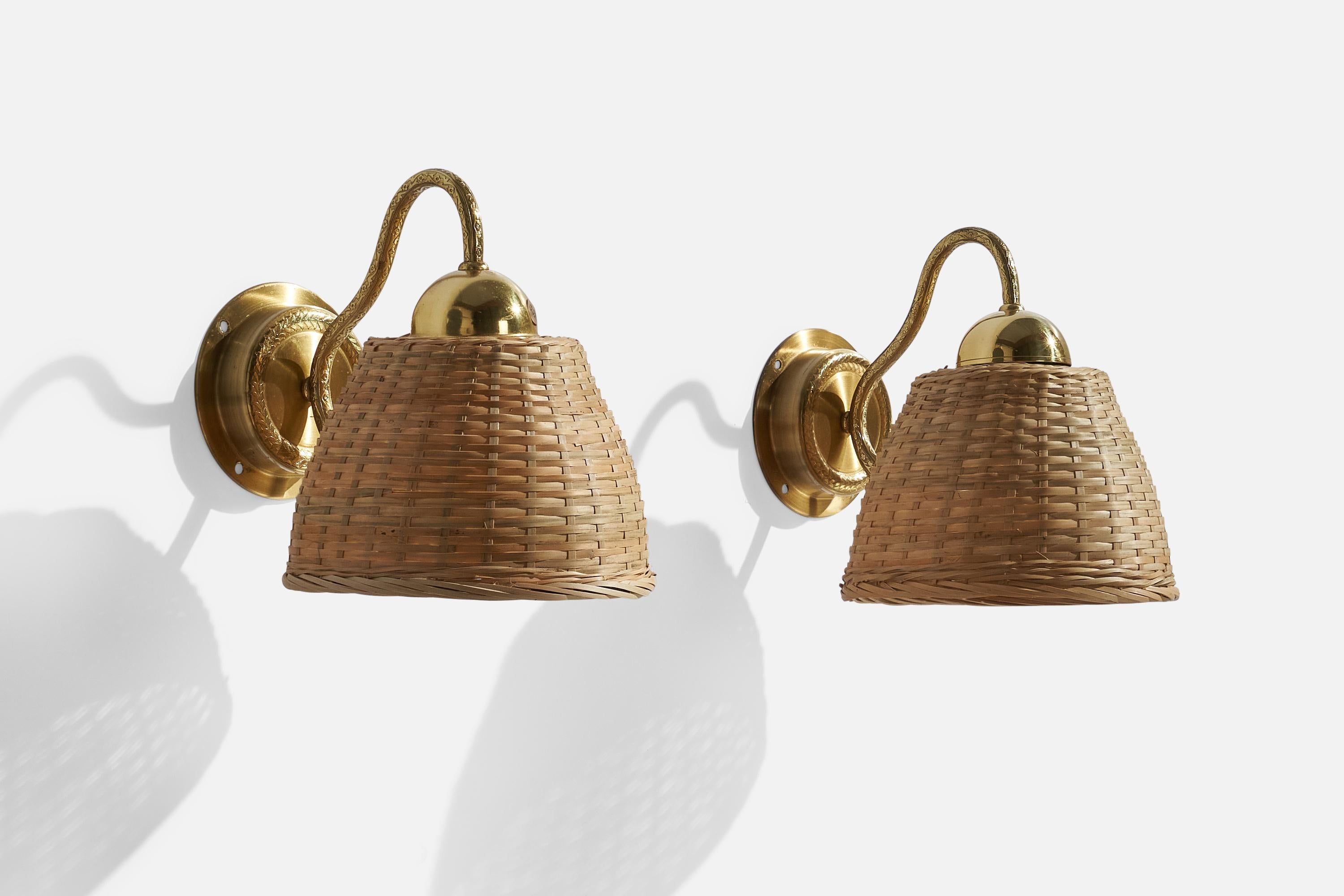 A pair of brass and rattan wall lights, designed and produced by EWÅ Värnamo, Sweden, c. 1970s.

Overall Dimensions (inches): 8.5”  H x 7” W x 9.5”  D
Back Plate Dimensions (inches): 4.25” H x 4.25”  W x 1.0” D
Bulb Specifications: E-26 Bulb
Number