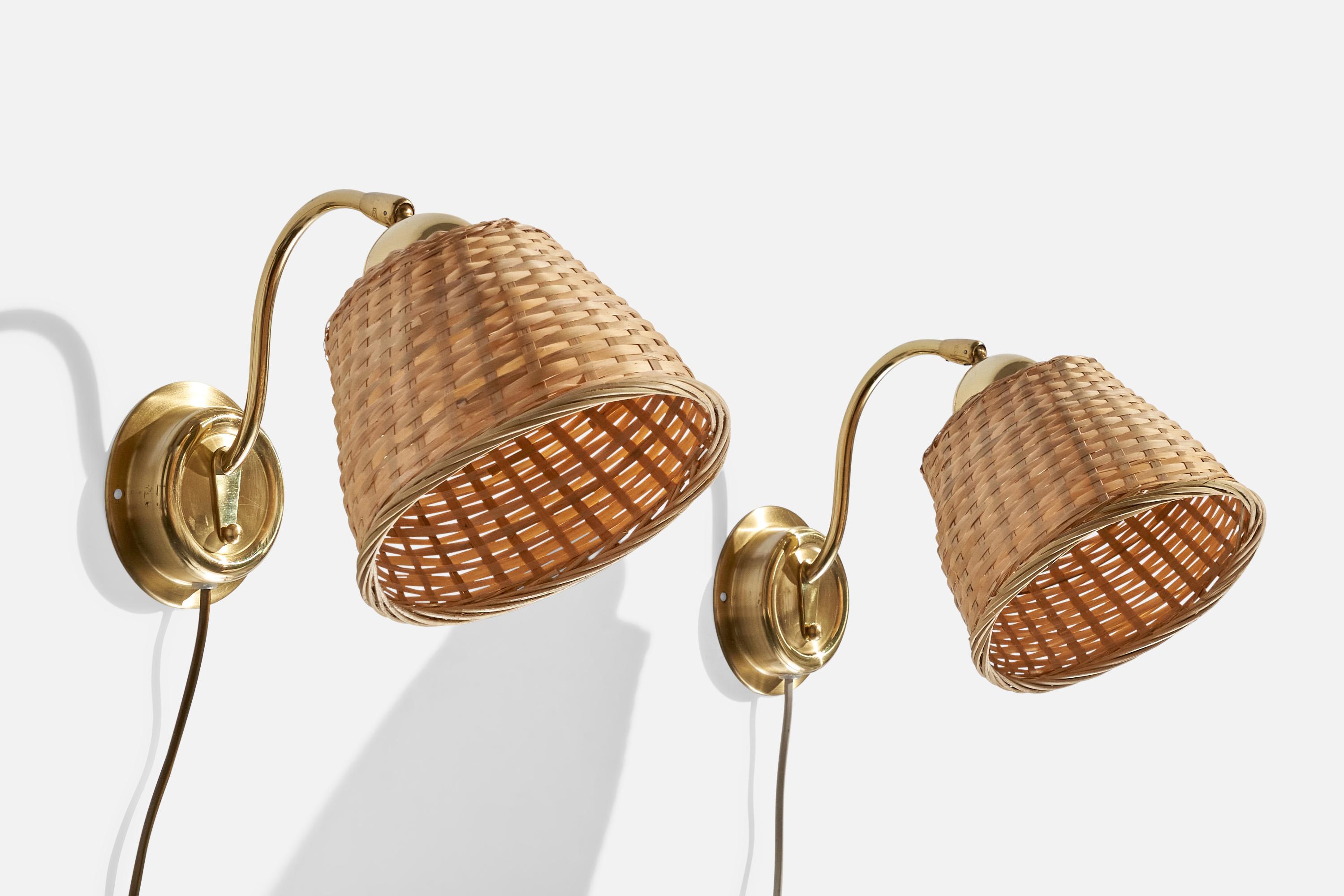 A pair of brass and rattan wall lights designed and produced by EWÅ Värnamo, Sweden, 1970s.

Assorted rattan lampshades.

Overall Dimensions (inches):  8.25” H x  7.125” W x  12“D

Back Plate Dimensions (Inches):  4.25” H x 4.25” W x 1.25” D

Bulb
