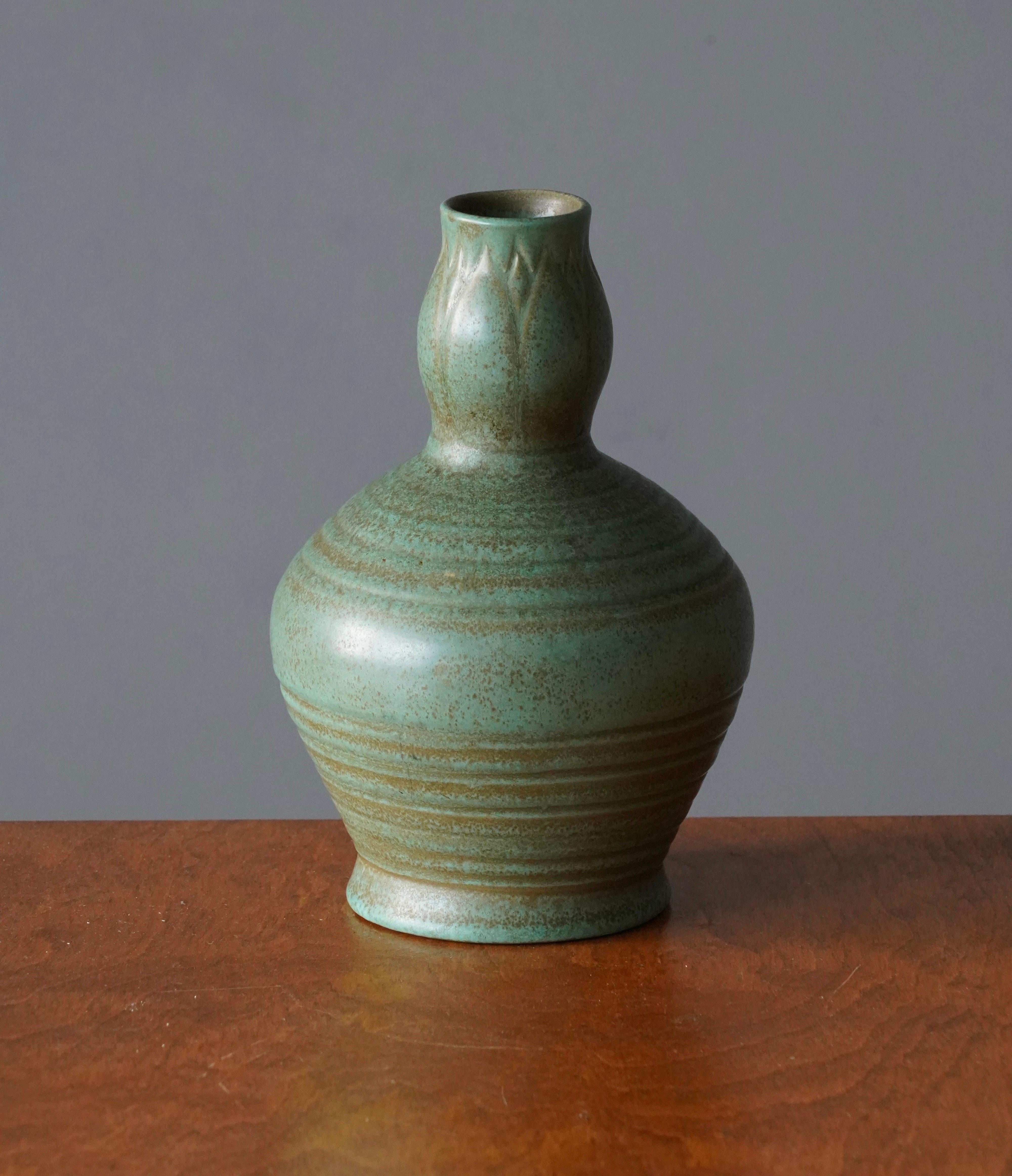 A vase. Designed by Ewald Dahlskog, produced by Bo Fajans, Sweden, 1930s. In earthenware, with subtle incised decor.

Marked 