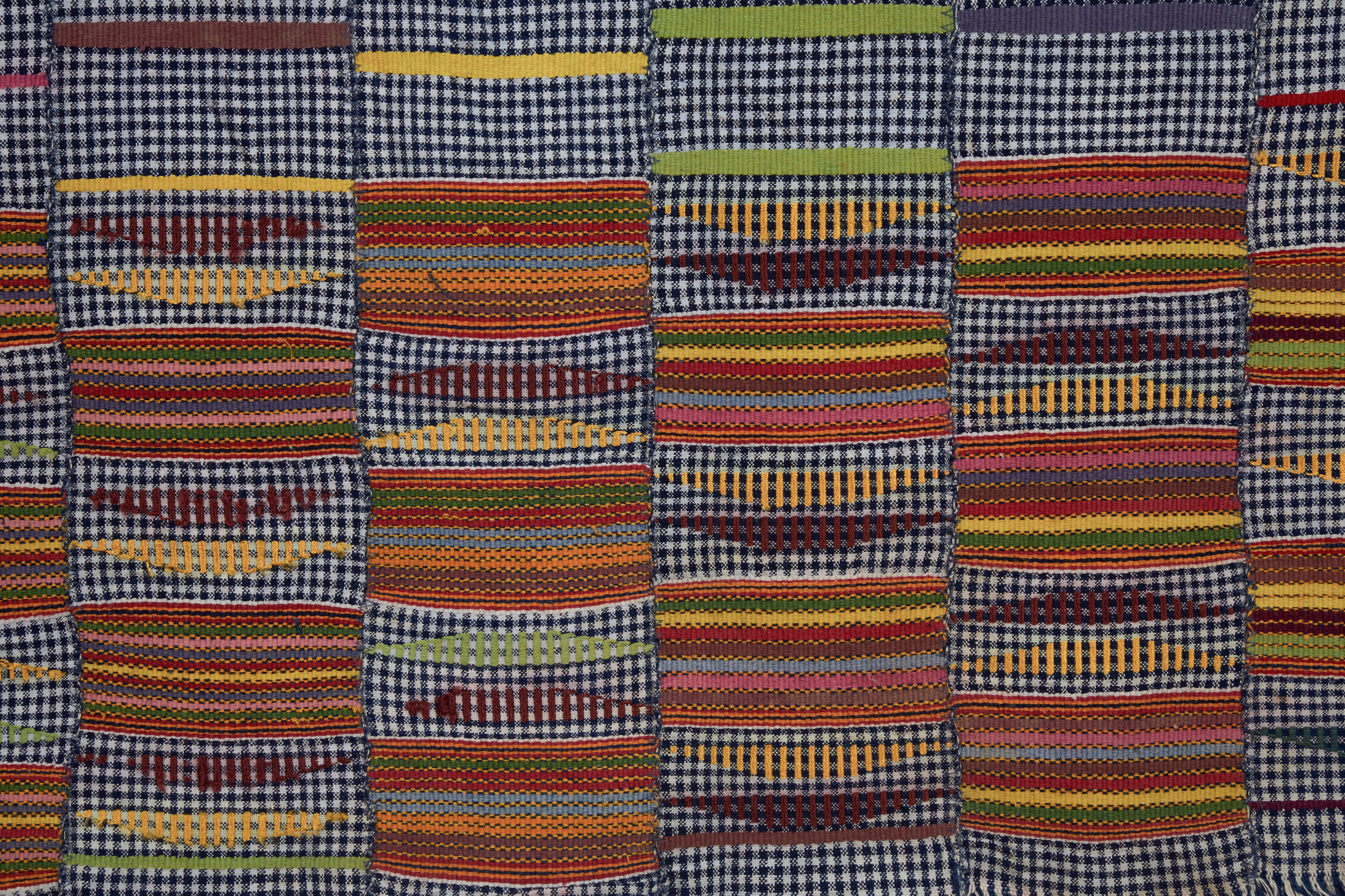 Strips of narrow handwoven cloth sewn selvedge to selvedge. Chequered cloth with warp and weft faced alternating blocks of color. Ghana, Africa.
 