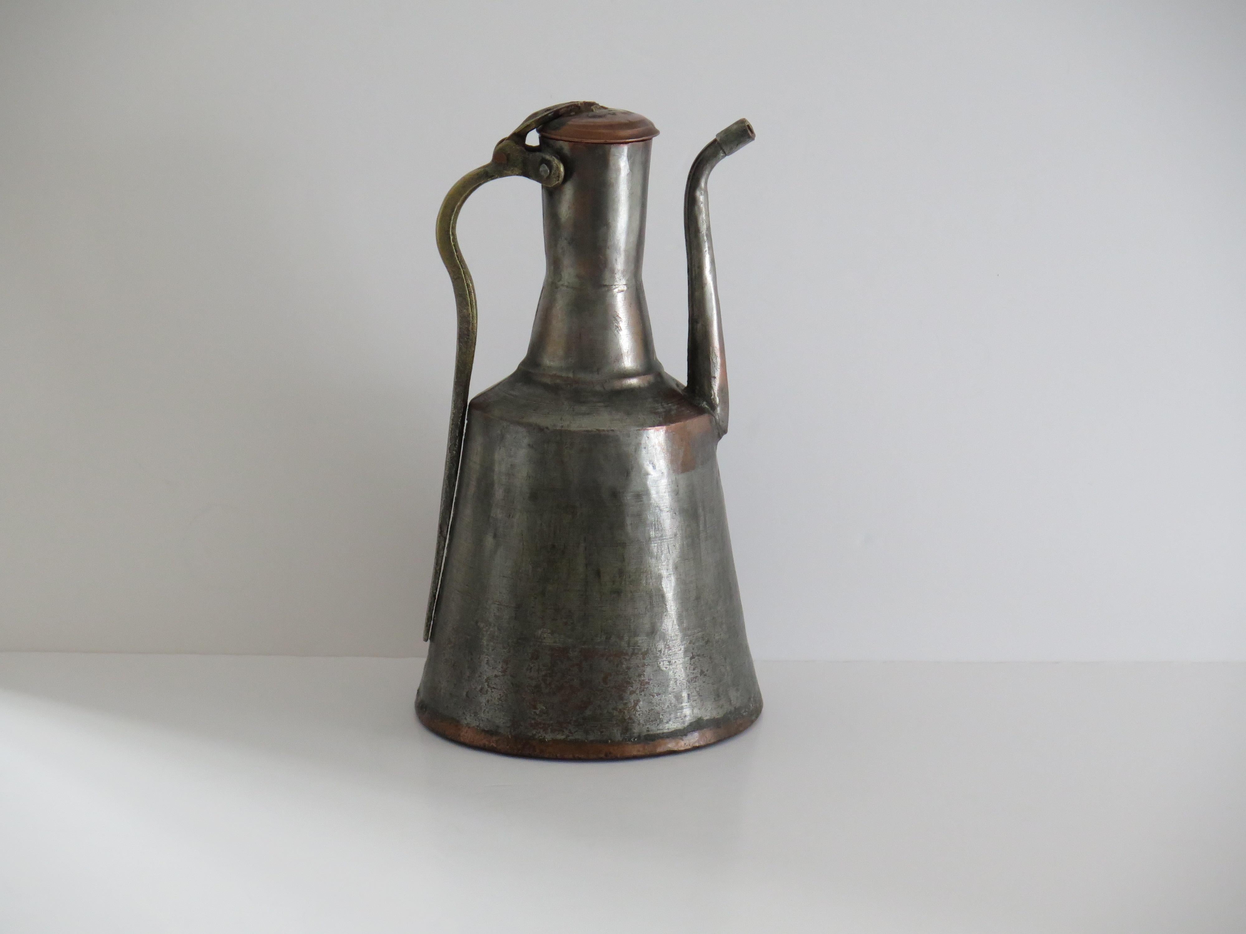 This is a handmade Ewer / Pitcher made from tinned copper and dating to the early 19th Century. It is of Islamic influence made in the Middle East, probably Turkey.

This piece is all hand made from non-ferrous metals, mainly copper and some brass.
