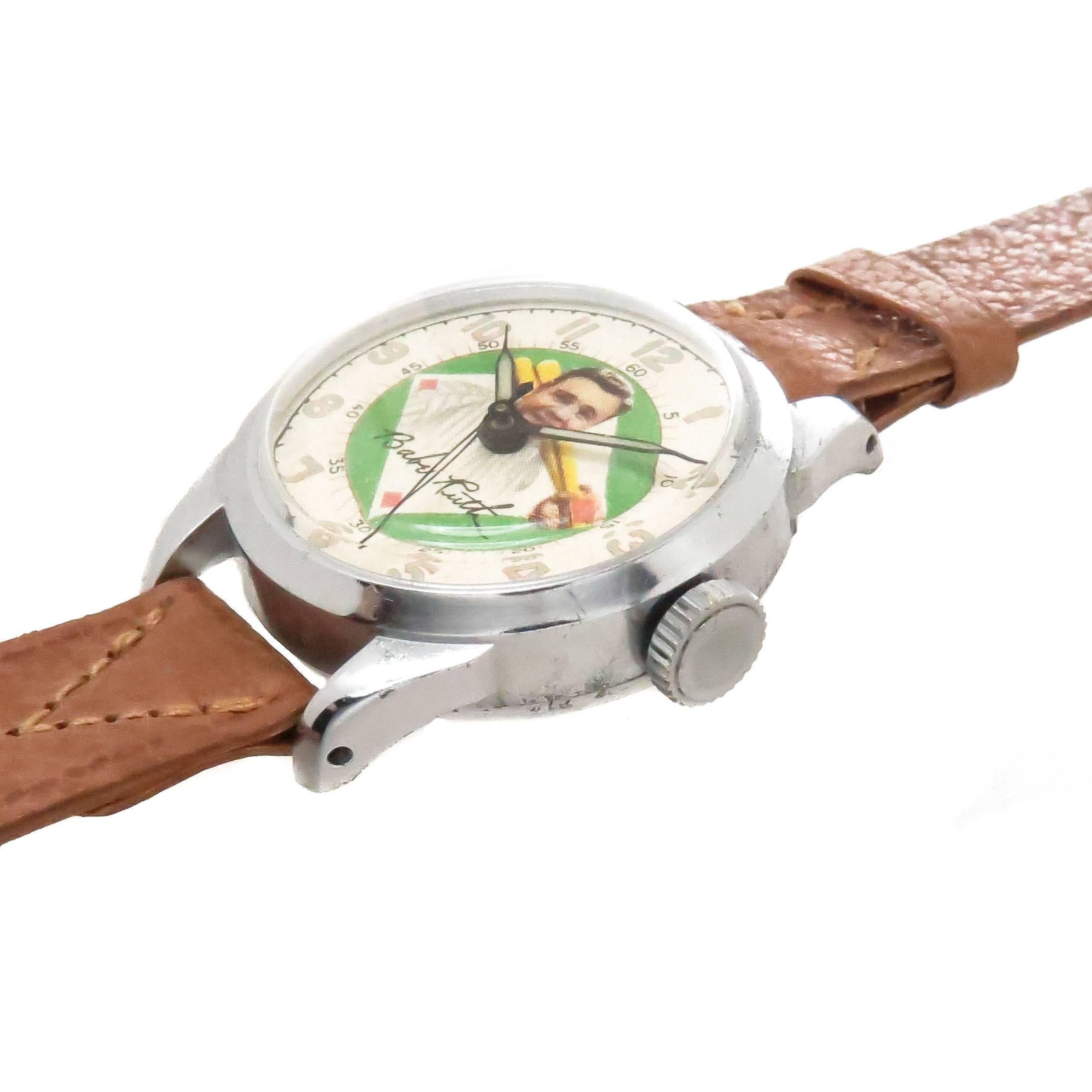 Circa 1948 Exacta Time Corporation Babe Ruth Wrist Watch, 33 MM Chromed Steel 2 piece case. Mechanical, manual wind pin lever movement. Very Bright and colorful Lithographed Dial with Luminous hands and a sweep seconds hand. The watch comes on a new