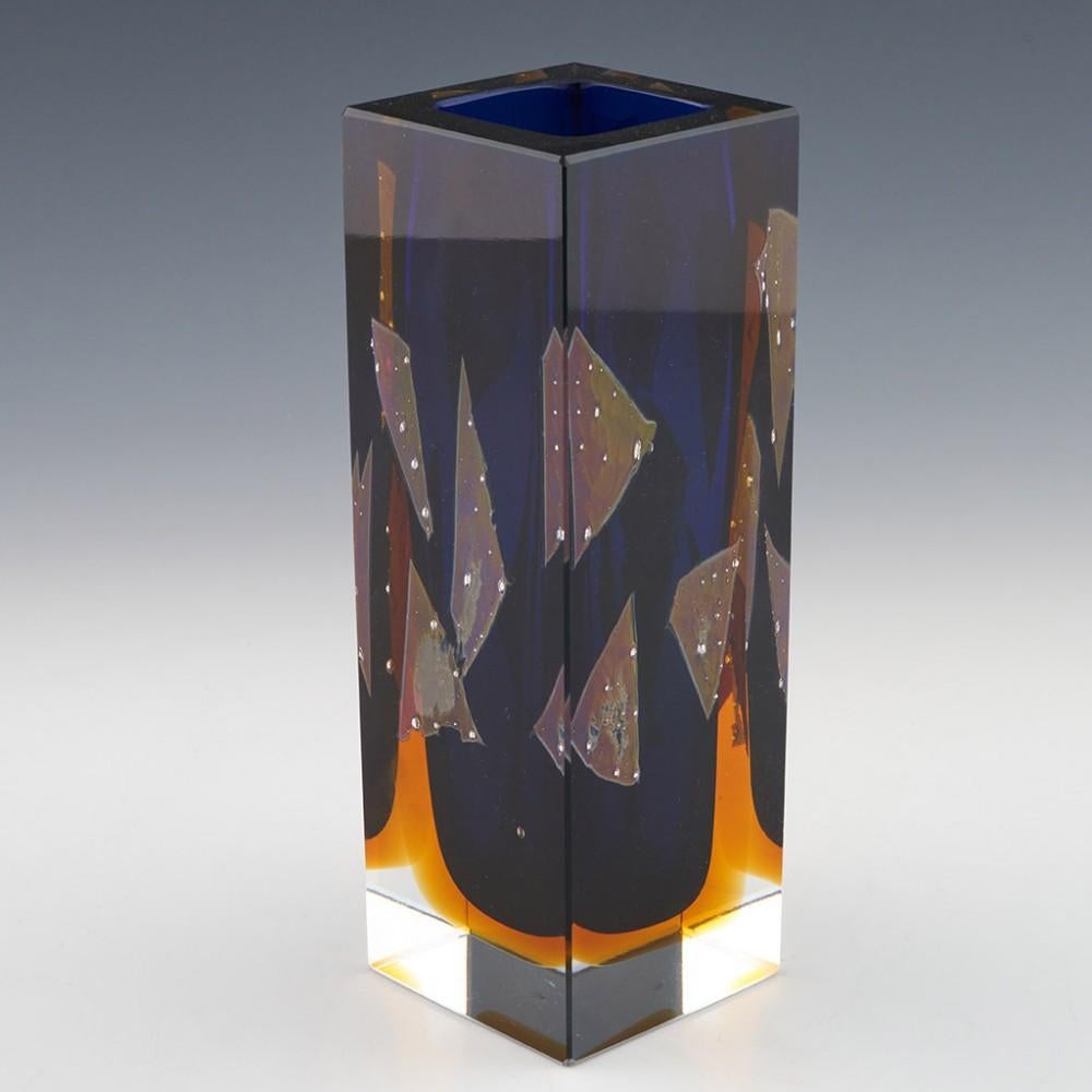 Exbor Cased and Cut Vase Designed by Pavel Hlava, 1964

Additional information:
Date : Designed 1964 - manufactured until the 1980s
Origin : Czechoslovakia
Bowl Features : Cased clear, blue, and amber cut glass vase with metallic foil