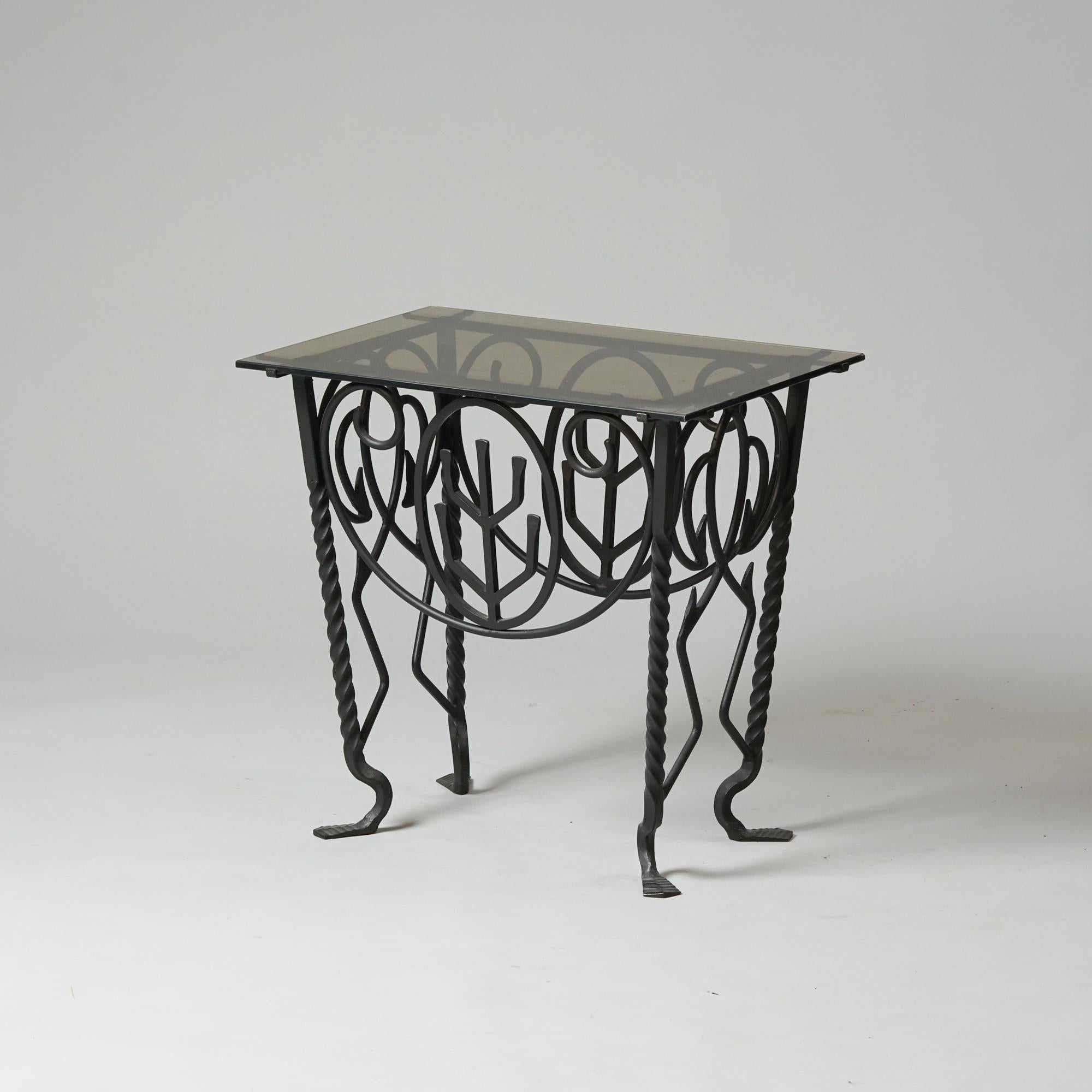Exceedingly rare iron table by Taidetakomo Hakkarainen from the Early 20th Century. Forged iron frame with glass table top. Good vintage condition, minor patina and wear consistent with age and use. 