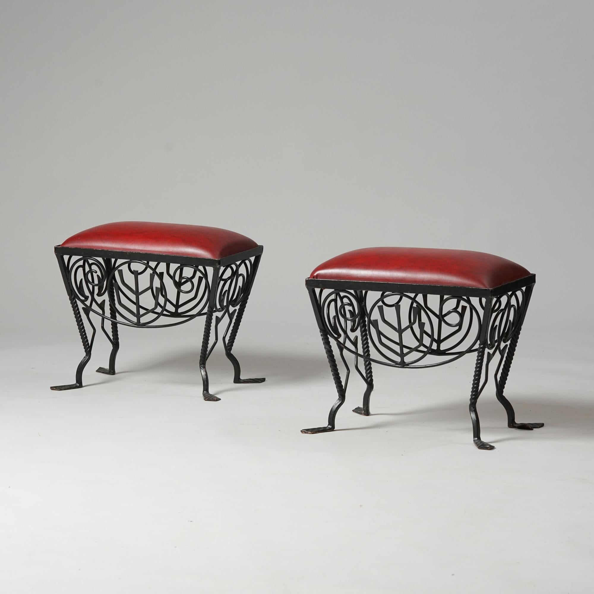 Exceedingly rare pair of stools by Taidetakomo Hakkarainen from the Early 20th Century. Iron with red imitation leather seat. Good vintage condition, minor patina consistent with age and use. The stools are sold together. 