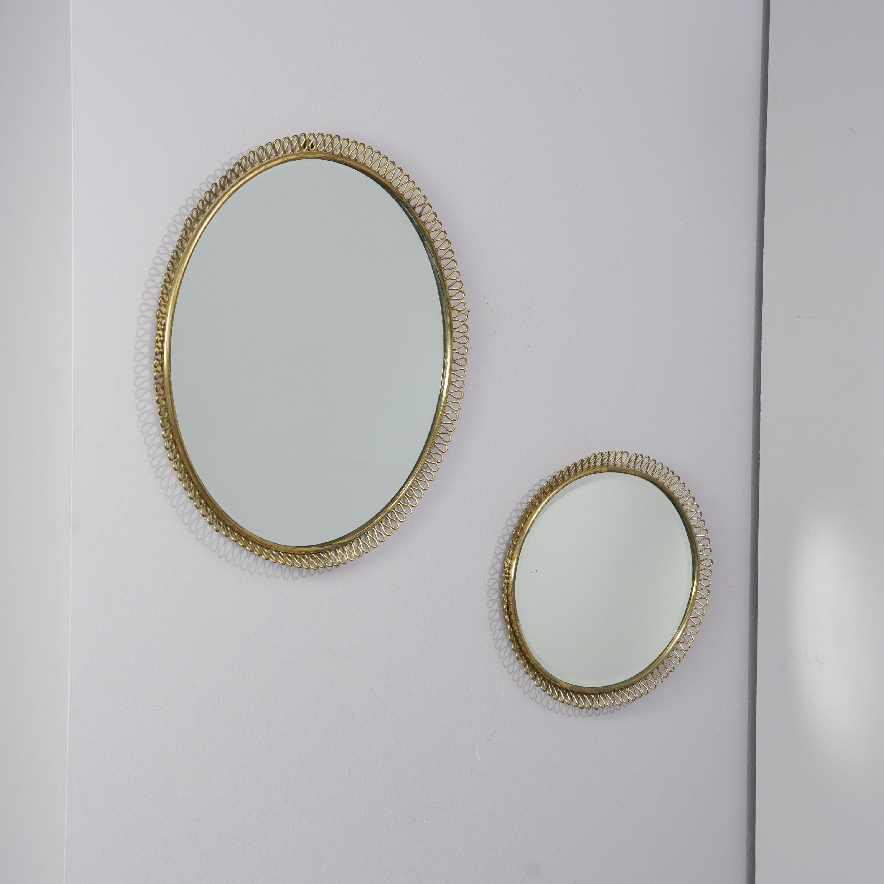 Exceedingly rare wall mirrors designed by Antti Hakkarainen for Taidetakomo Hakkarainen, stamp on the bottom, circa 1930s, brass, very good condition, minor wear consistent with age and use. The mirrors are sold as a set. 

Measurements for the