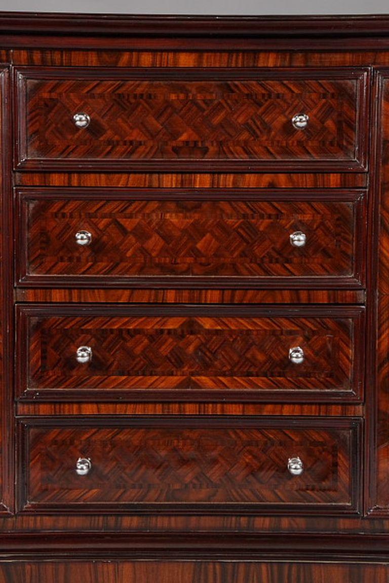 Excellent French bar commode/sideboard in Art Deco style

Fine wood veneer on solid fir wood. Oval-shaped 4-jib body. Veneered on all sides. Back, sides Drawer front and cover plate are provided with a large diamond-shaped pattern. This furniture is