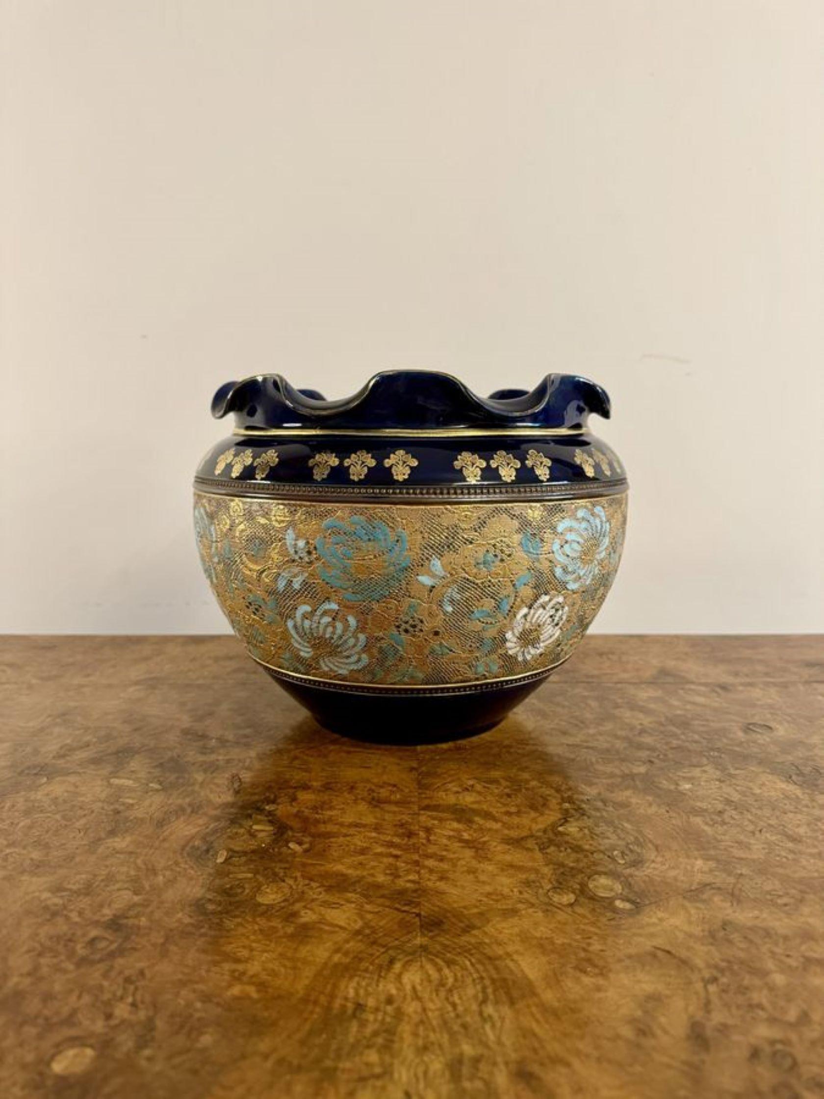 Excellent quality antique Royal Doulton jardiniere having a quality antique Royal Doulton jardiniere with a blue wavy shaped top with gold gilded decoration, having a centre panel on a gold ground with pretty floral decoration in stunning gold,