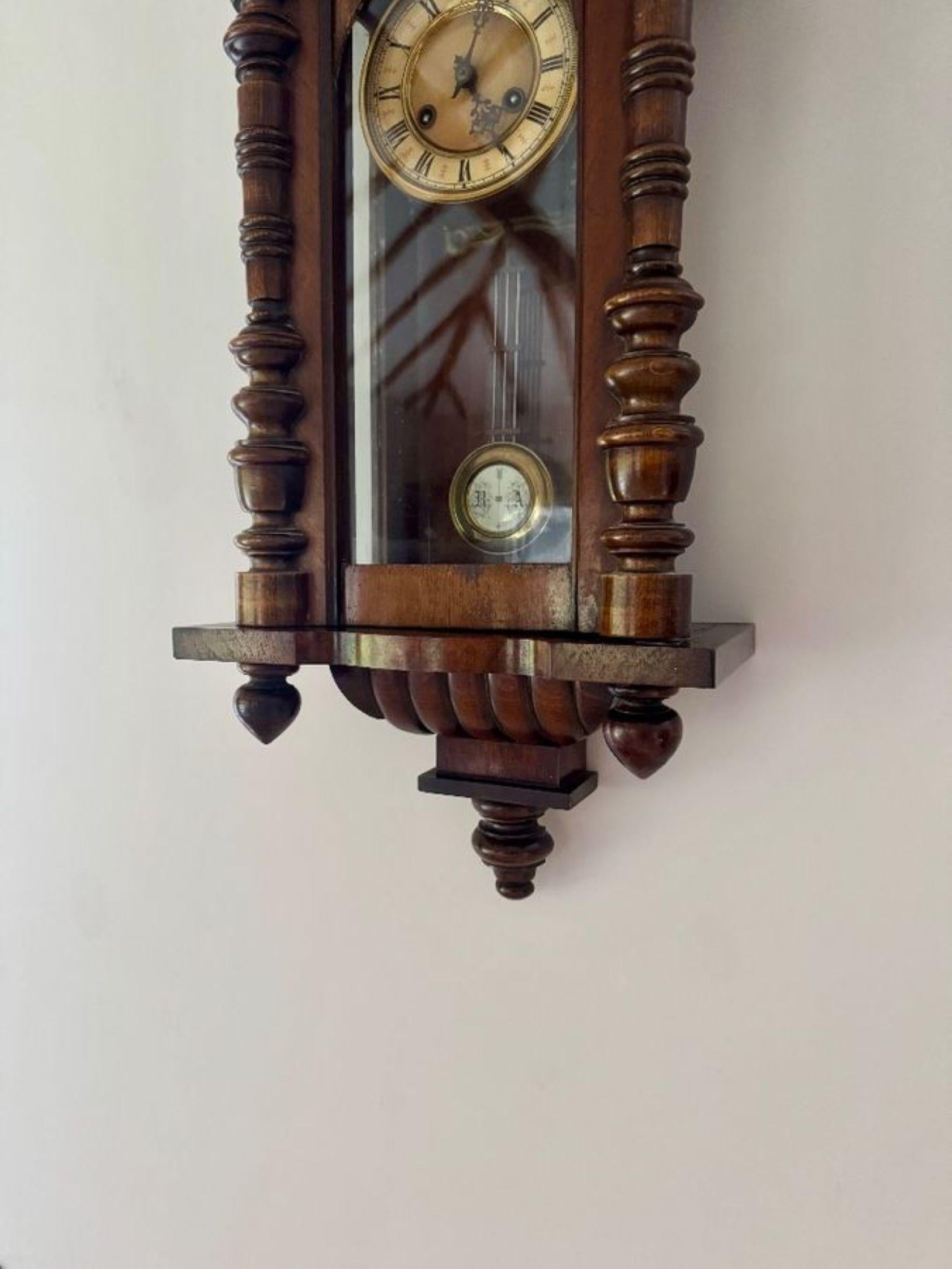 Excellent quality antique Victorian quality carved walnut Vienna wall clock having turned columns, original finale's with a shaped top and bottom. Single walnut glazed door opening to reveal a circular porcelain dial with the original hands with