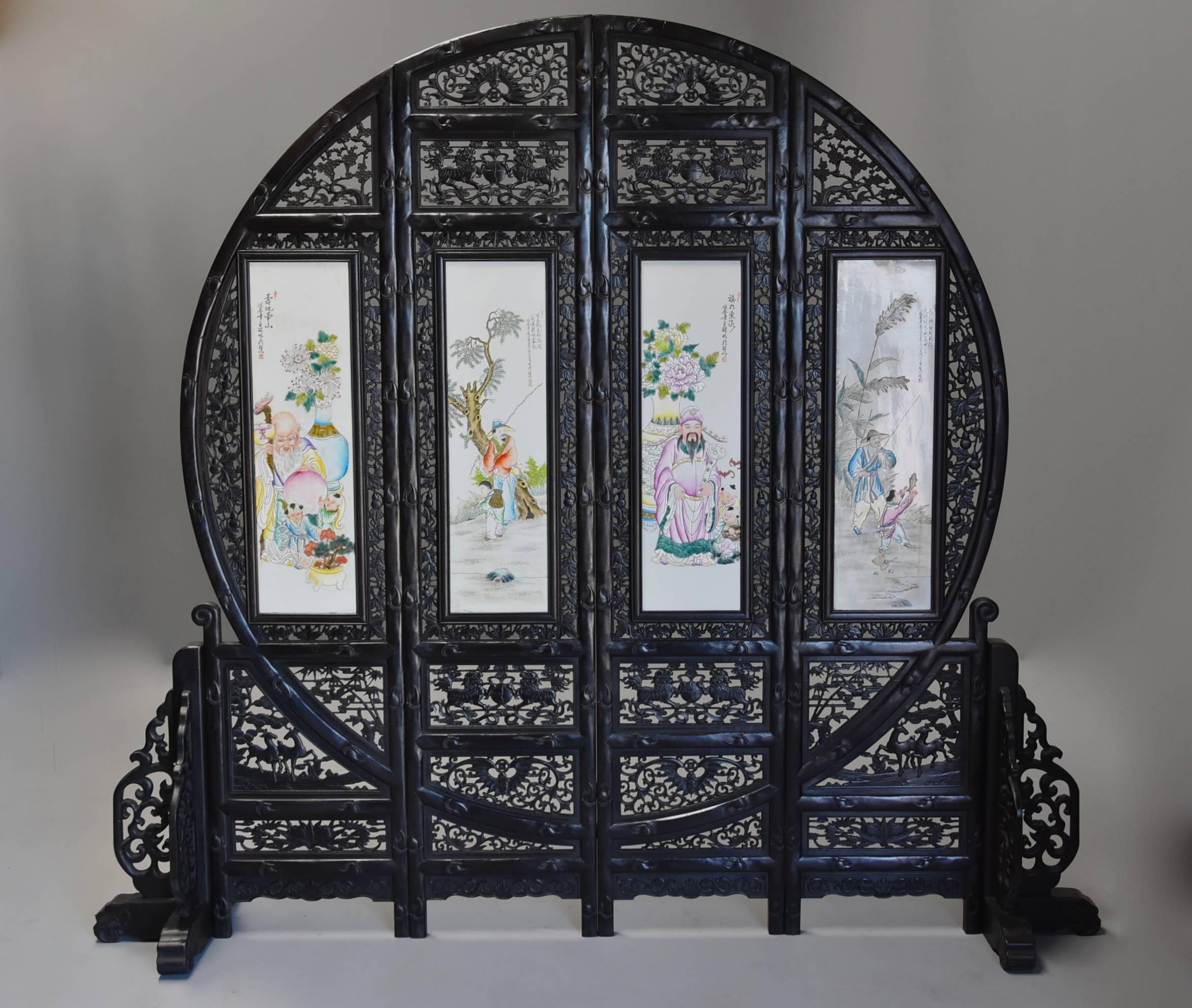 A 20th century highly decorative and excellent quality large circular Chinese carved hardwood four panel and double-sided screen.

This screen consists of four double-sided carved hardwood panels that interlock together to form a circular shaped