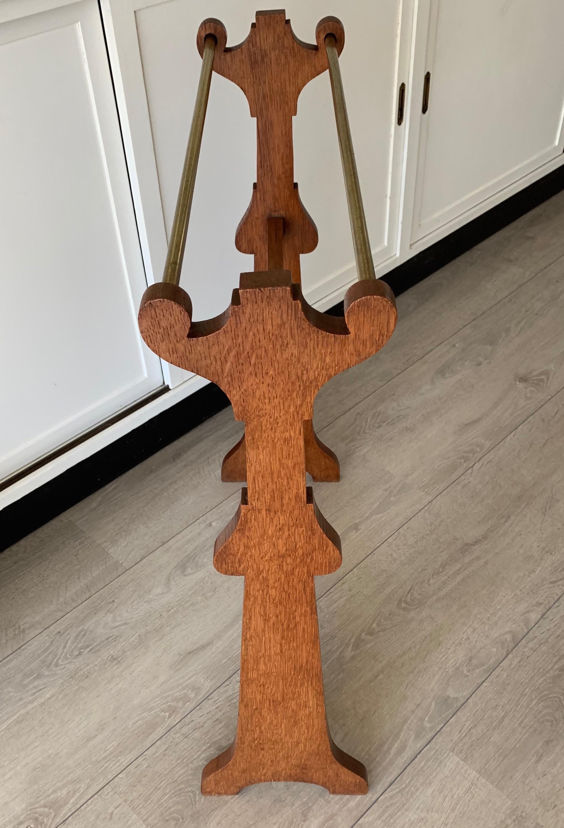 Excellent Shape and Condition Elegant and one of a kind towel rack from the early 1900s.

This handcrafted, solid oak towel rack comes with circular brass rods for hanging your towels on. It is in perfect condition and thanks to its design, this