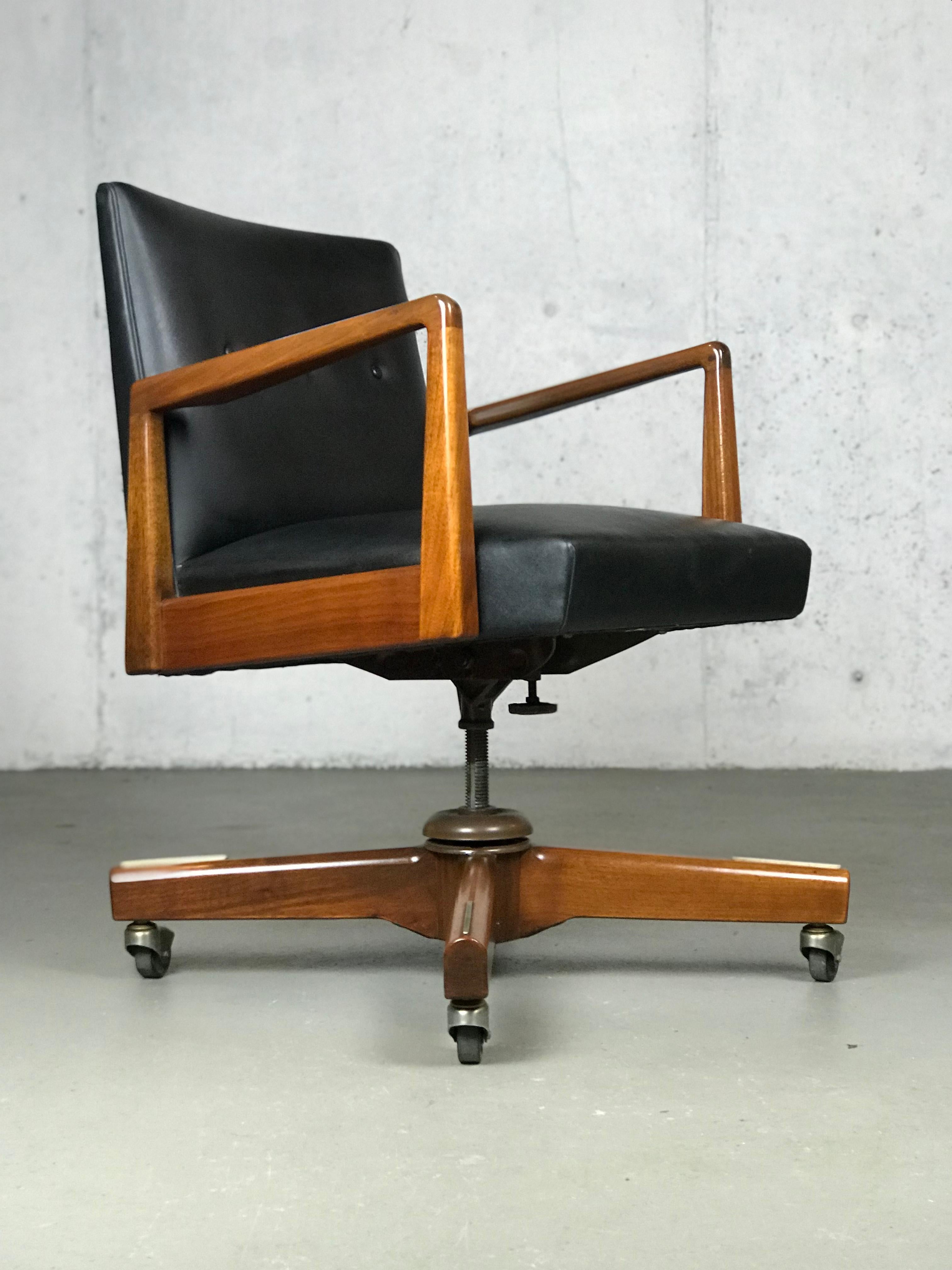 Nice original Jens Risom executive office chair. Walnut has its original finish. Nice detail with the aluminum footrests on the legs and the arm cut-outs by the seat back. Minor wear on legs. A small spot of wear or loss to the vinyl on top back