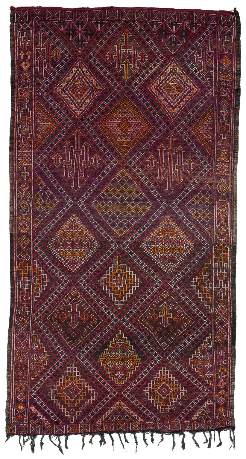 This Moroccan rug is in perfect condition, very soft wool, with lots of deep indigo blue and reds and oranges. Like smoldering coals burning in a night sky or a stained glass window. A truly mystic piece. Measures: 6' x 10'10''.