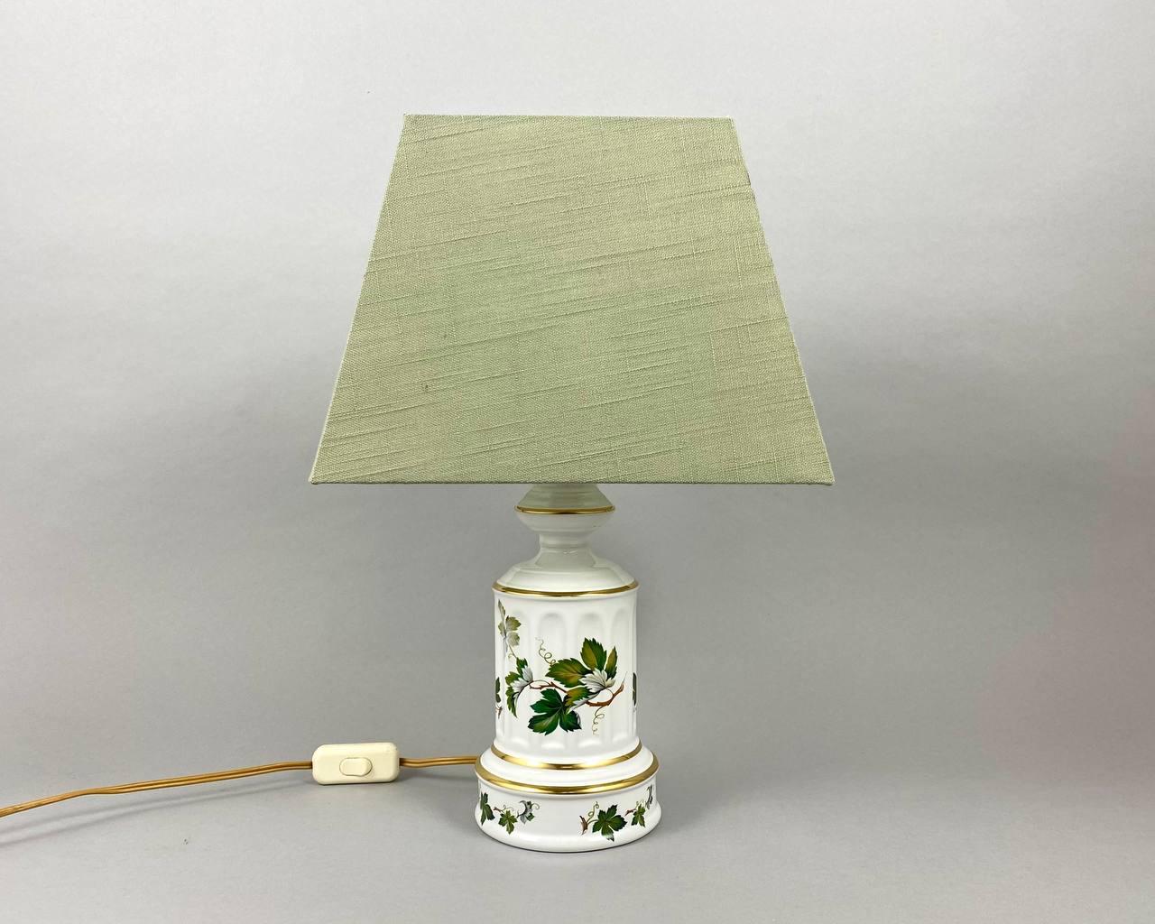 Vintage porcelain table lamp from Porcelain De Bruxelles, Belgium.

 Beautiful base made of white porcelain with elegant floral decor and gilding.

 The lampshade is new, covered with a mint-colored fabric.

 The convenient switch is located