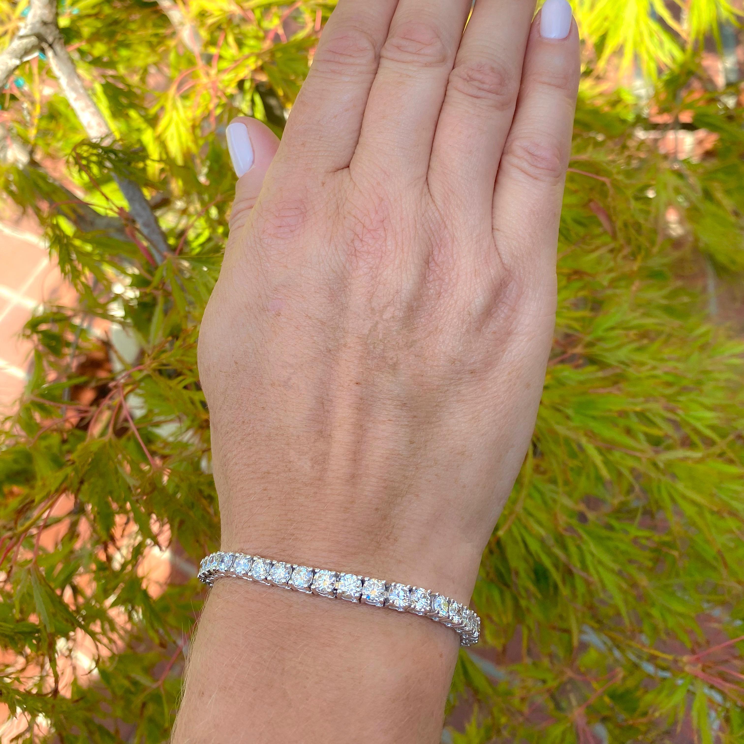 With traffic-stopping brilliance, this 14k white gold tennis bracelet is sure to please! Prong-set with 38 sparkling round brilliant-cut diamonds, with a total weight of 12.65-carats, G-H color and VS-SI clarity. The bracelet weighs 21.5 grams, and