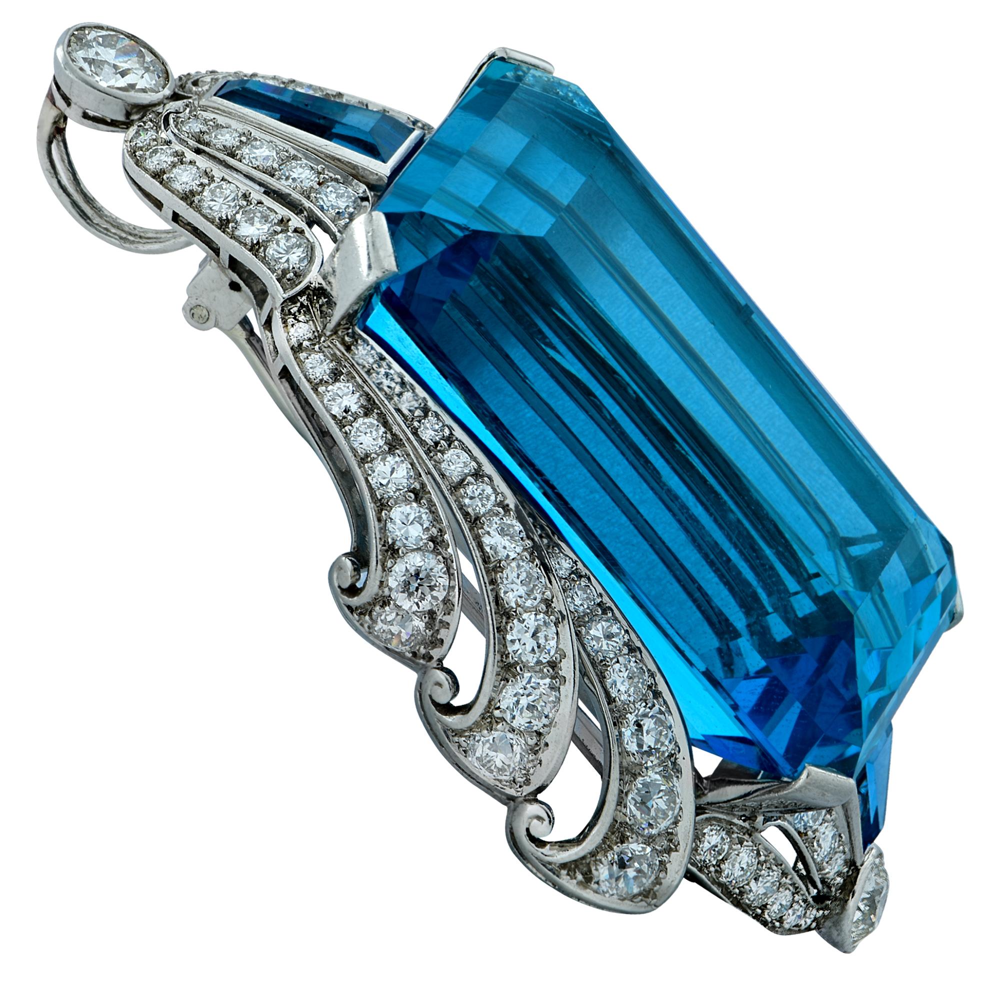 Sensational Art Deco brooch necklace crafted in platinum featuring an exceptional emerald cut Santa Maria intense blue, AGL certified Natural Aquamarine, weighing approximately 135 carats, accented by 86 European cut diamonds weighing approximately