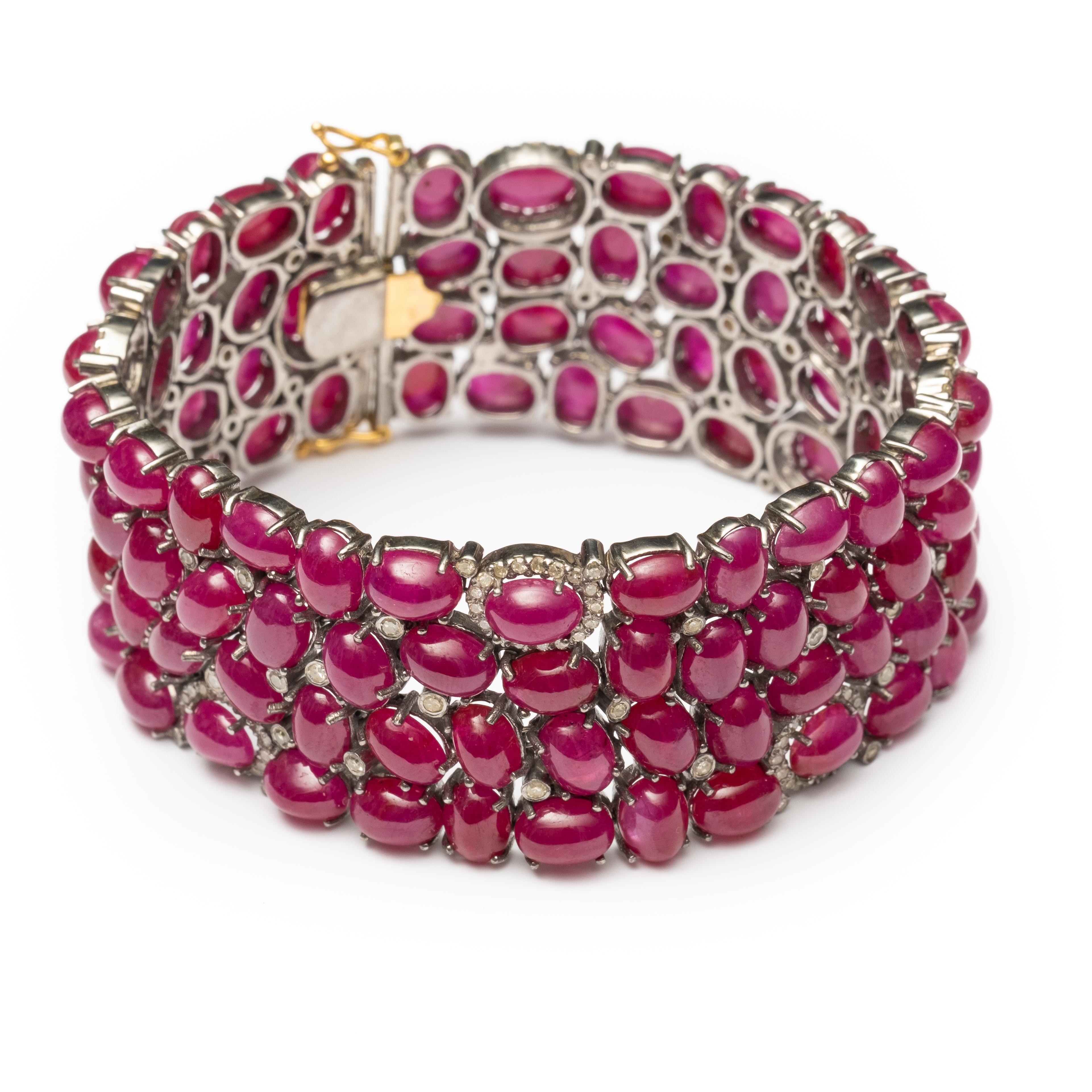 Exceptional Ruby and diamond bracelet with numerous oval cabochon rubies measuring approximately 6.30 x 4.50 mm and numerous single cut diamonds weighing approximately 2.90 carats total. Mounted in silver with gold clasp. 7 inches long. Clasp stamp: