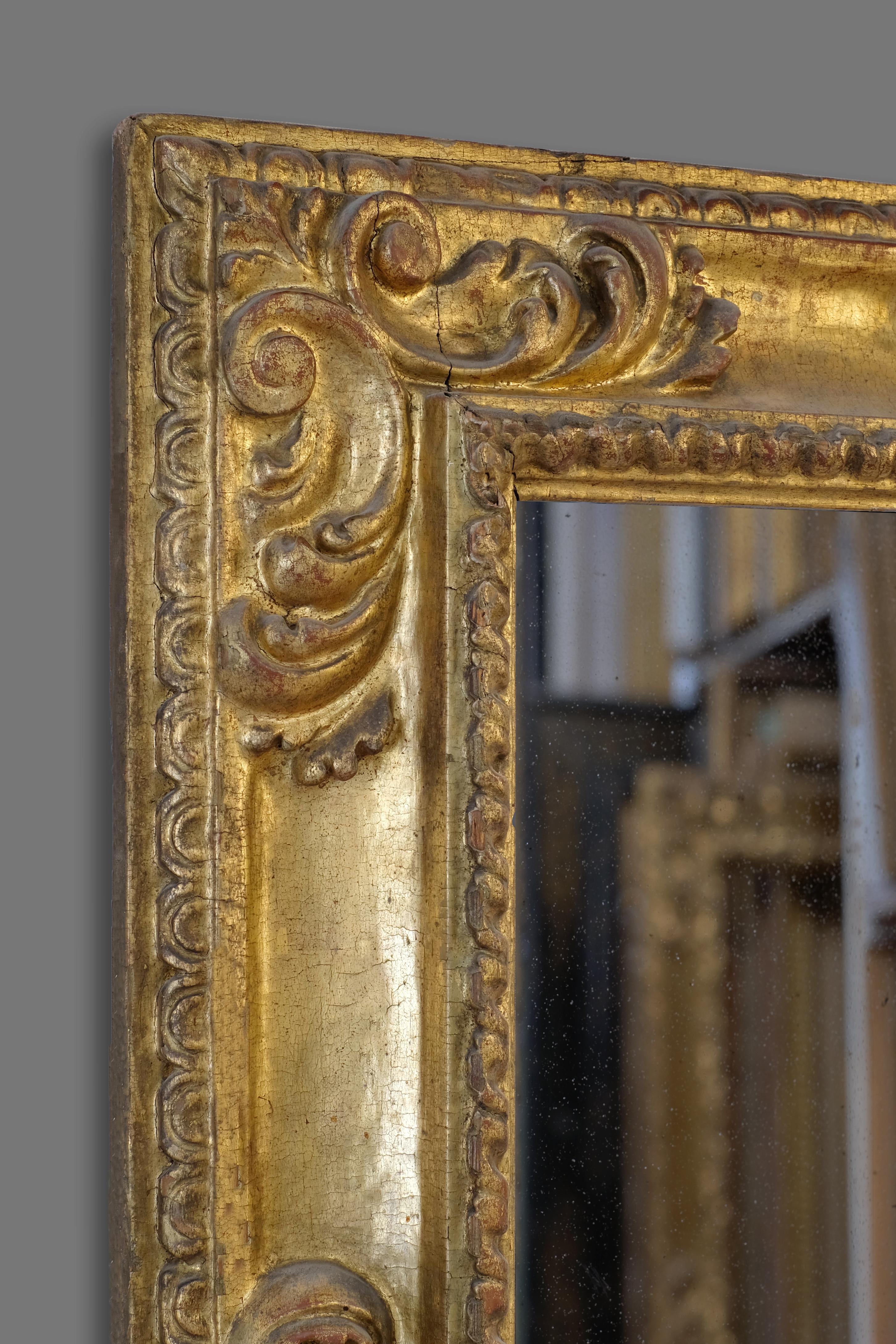 This exceptional 17th century hand carved Spanish Baroque frame is very rare and key example of its kind, with its carved gadrooned sight edge, corner and centre foliate scroll cartouches and scalloped back. The frame retains its well preserved