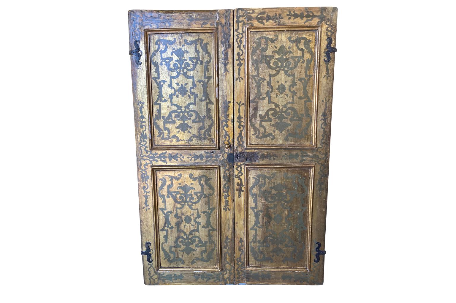 An exceptional and truly outstanding pair of doors from the Lucca, Italy. Wonderfully constructed from polychromed and gilt wood - retaining their original mercury mirror. The doors are wonderfully finished on both sides. Tremendous quality with