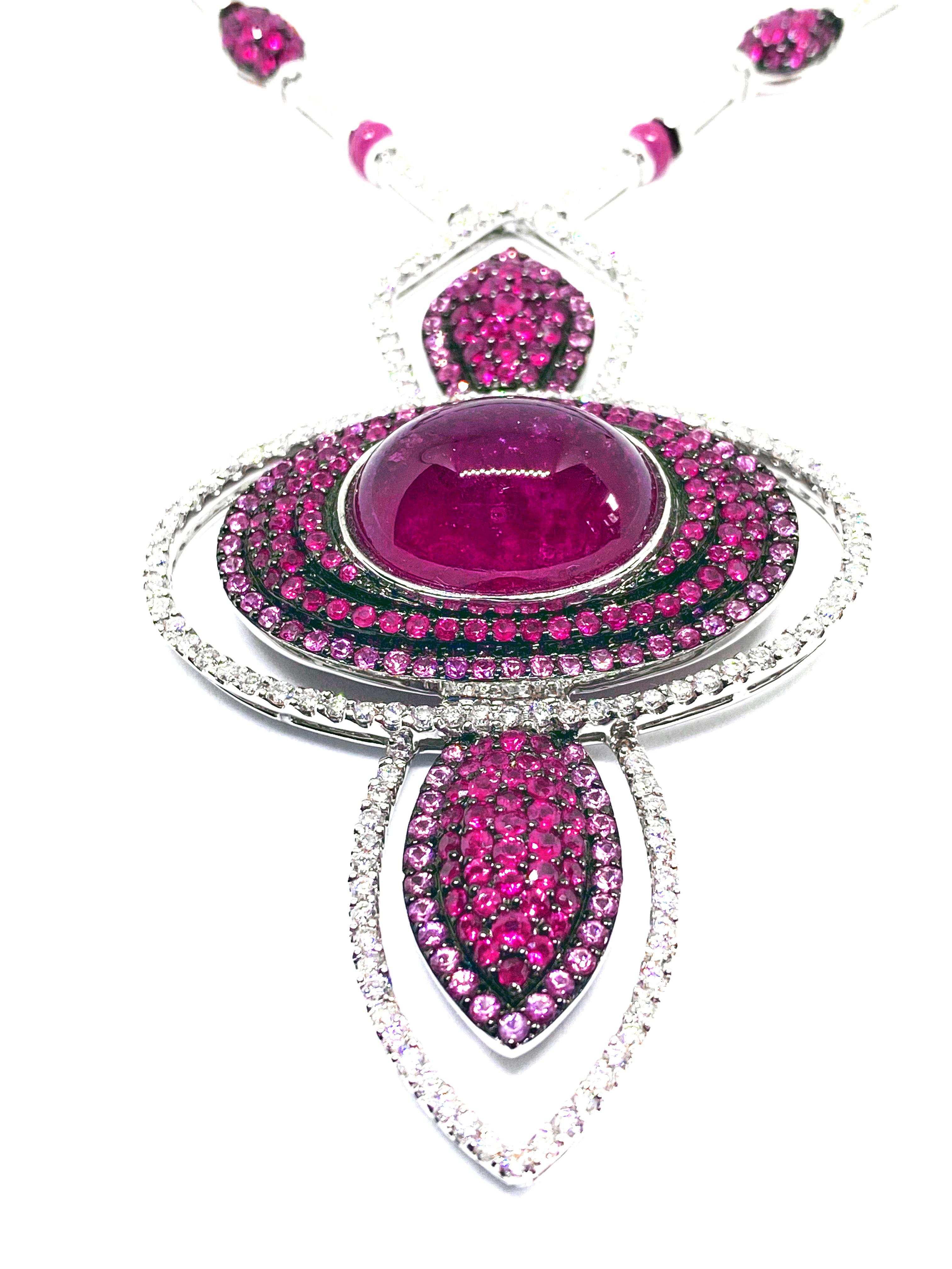 baroque pearl with pink tourmaline set in 18kt gold disc with ruby