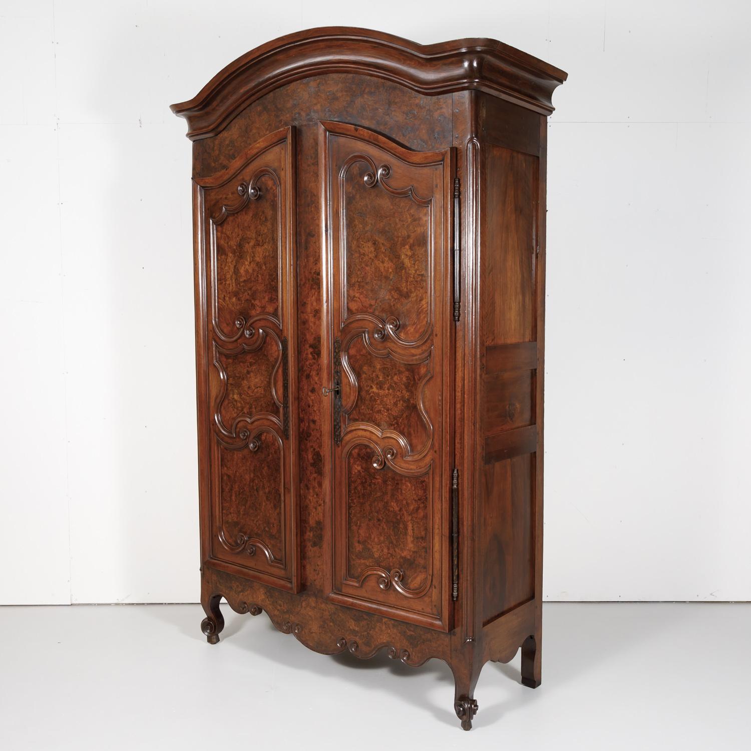An exceptional 18th century French period Louis XV armoire handcrafted of indigenous old growth walnut and burled walnut in the typical technique mastered by the skilled artisans of the Bresse region of France, circa 1750s. This large provincial