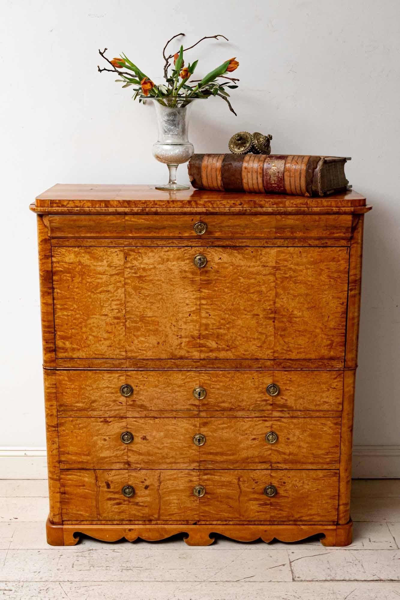 An exceptional 19th century Swedish Birch secretaire or Bureau with a beautiful grain and warm mellow color.
It features one long shallow top drawer over a fall front which opens with a key to reveal a stunning polished interior featuring many