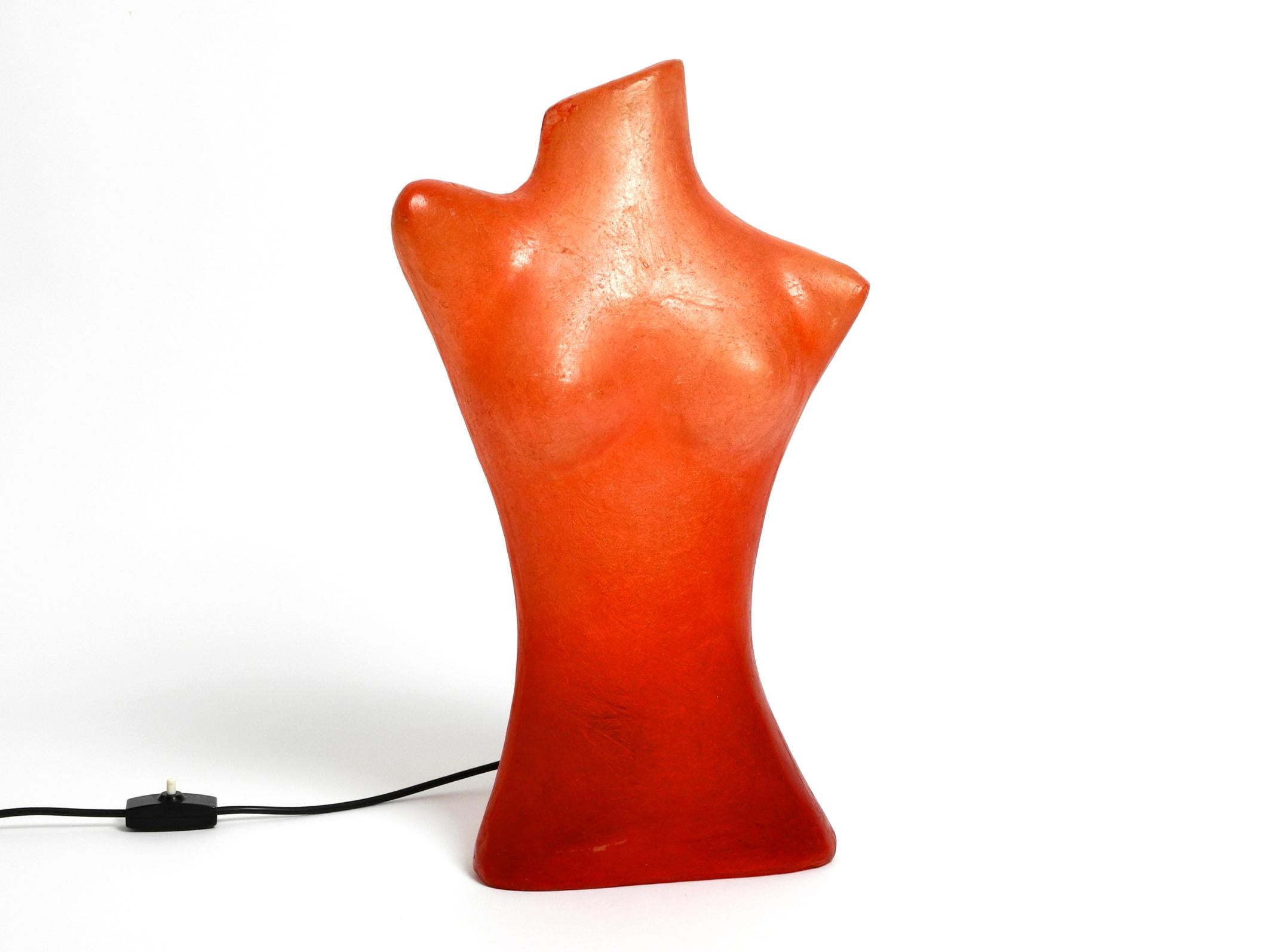 Exceptional 1960s woman torso table lamp made of fiberglass in red.
Torso is made of white fiberglass painted in red.
Pleasant glare-free ambient light for all living areas.
With one original E14 socket for small bulbs. 
The socket is simply