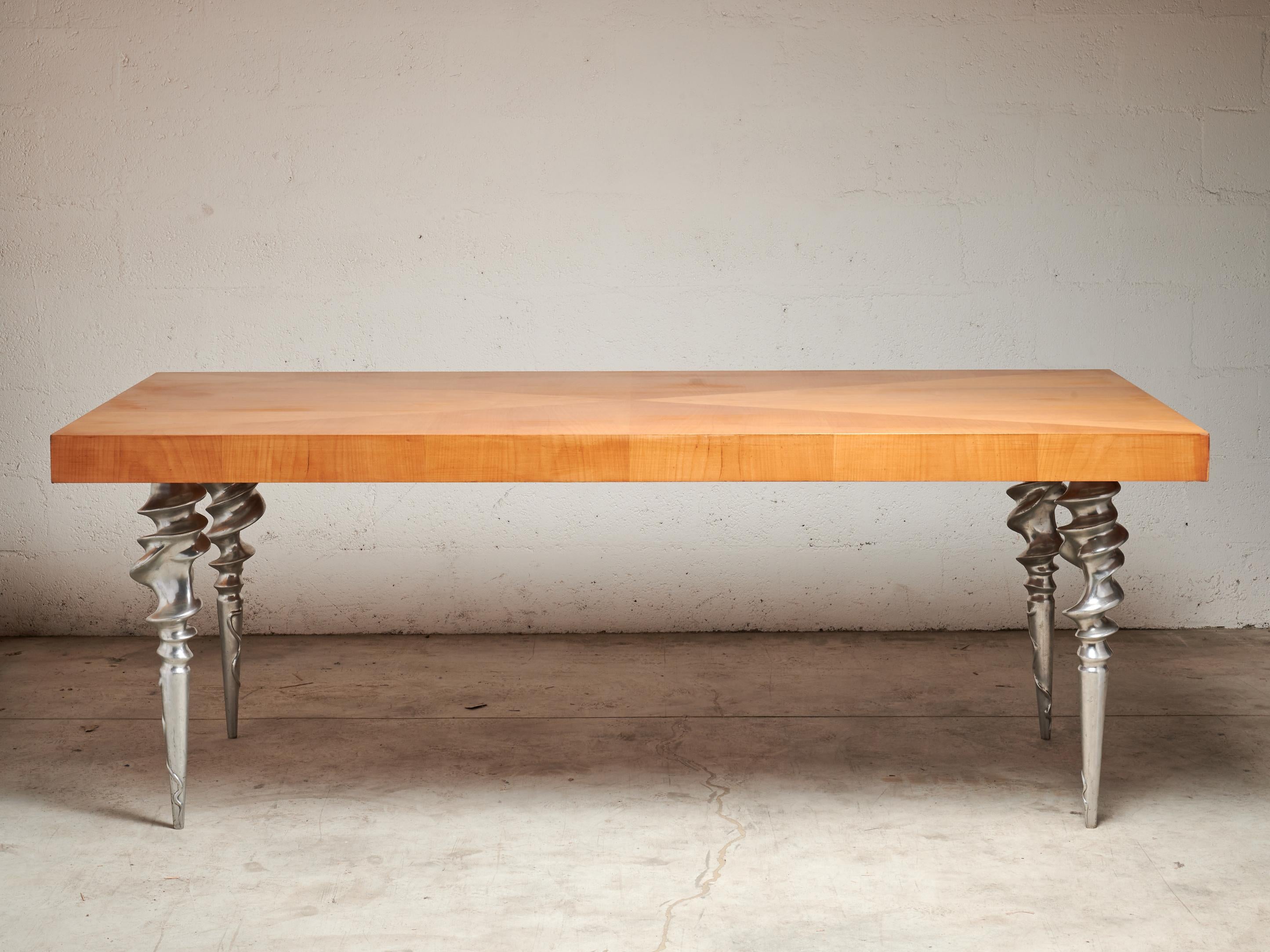 Raro tavolo con piano a intarsio e gambe a spirale in fusione di alluminio
Lavoro del 1980