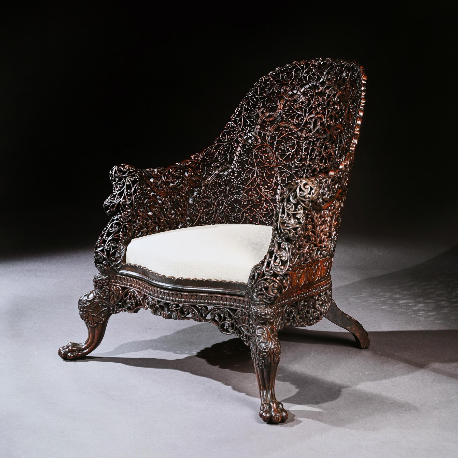An exceptional Anglo-Indian armchair profusely carved dating to the mid-19th century.

Bombay India, circa 1840.

Extremely well drawn, this design is rarely seen following closely in the footsteps of the English Regency period with its elegant