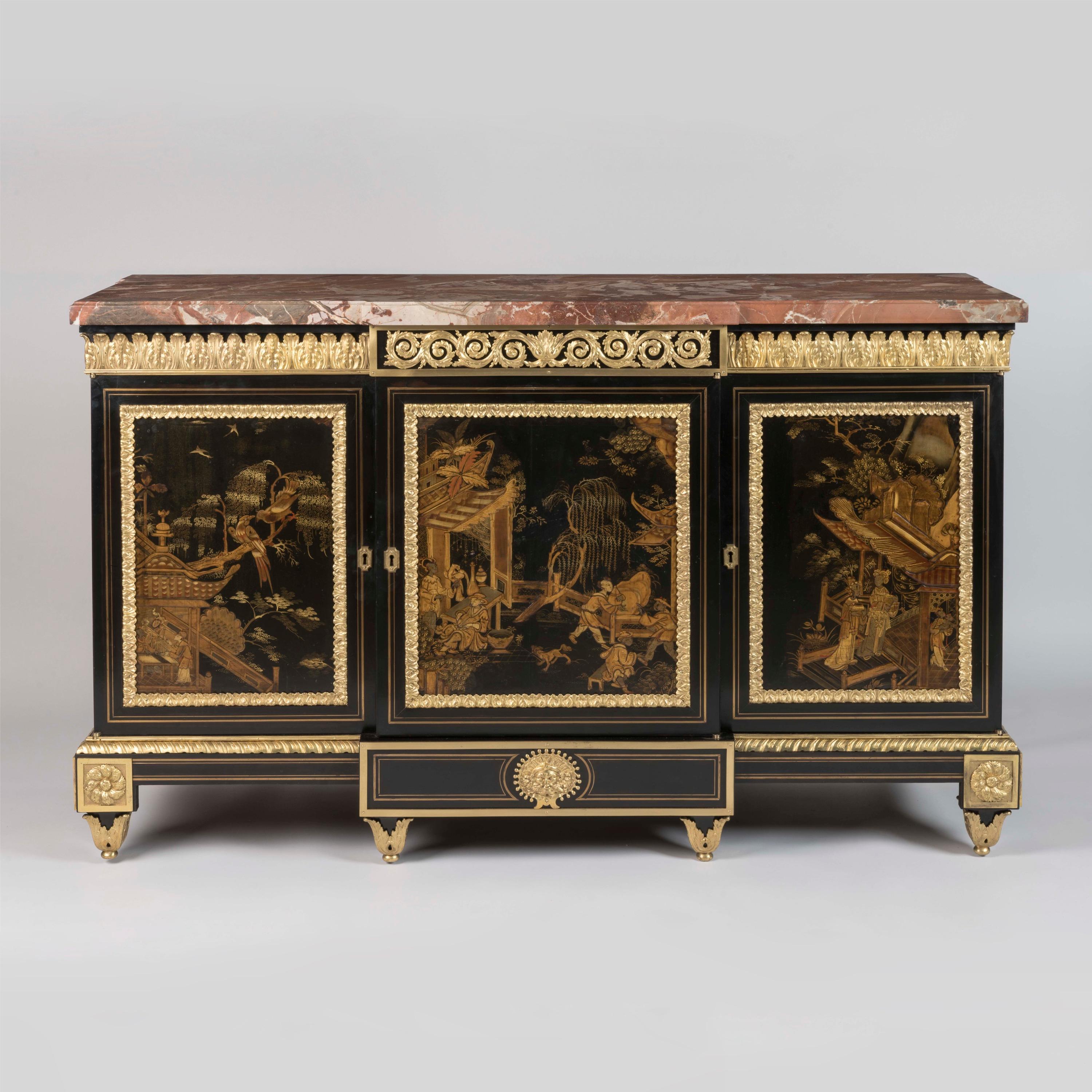 An Exceptional Lacquer-Mounted Side Cabinet
In the Antiquarian Taste

Possibly Supplied by Baldock

The original marble top with thumbnail moulded edge, above the breakfront cabinet rising from tapering feet shod with acanthus cast sabots, the apron