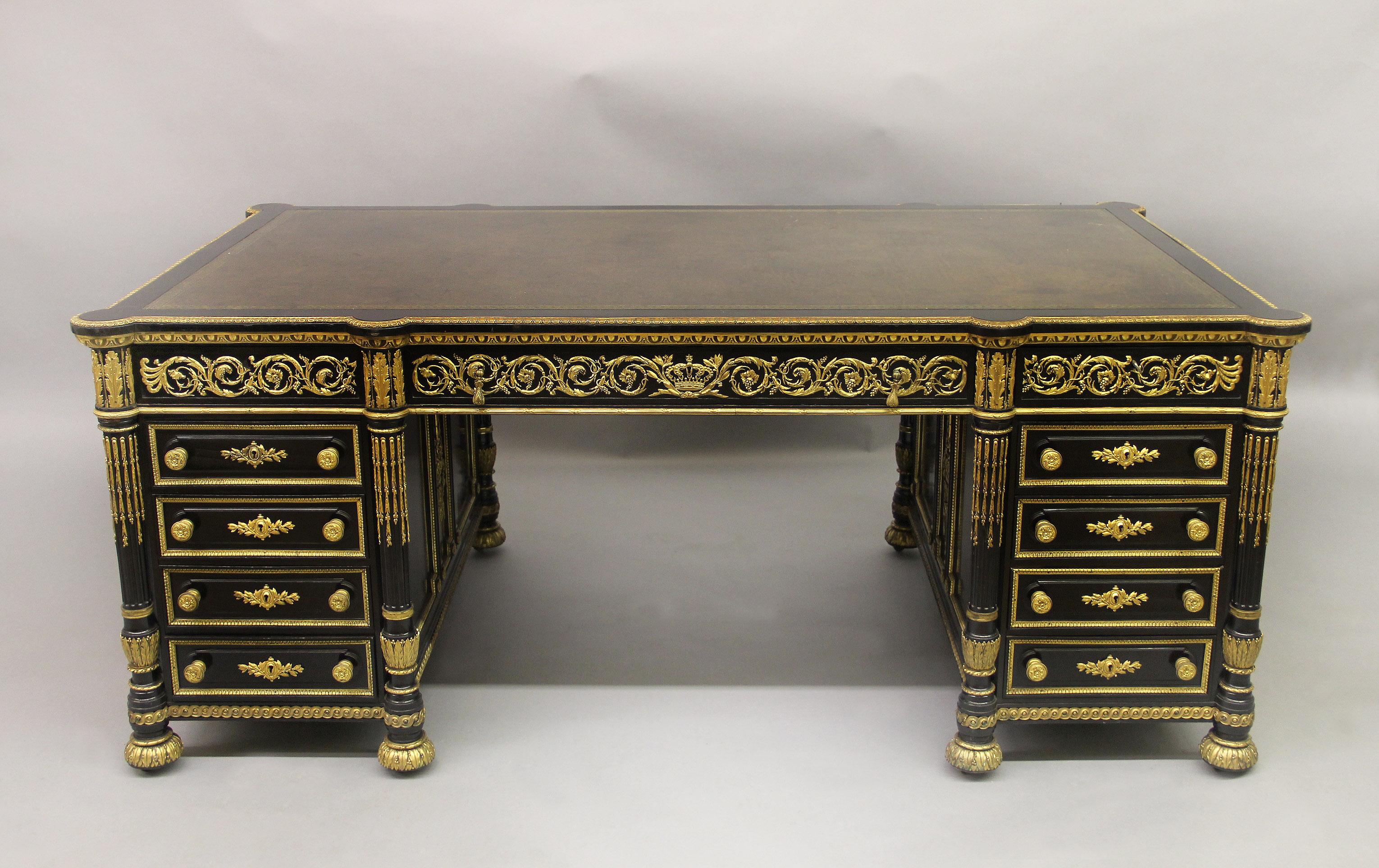 An exceptional and unusual 19th century Louis XVI style gilt bronze mounted English partners desk made for the French market

The rectangular top with gilt-tooled leather writing-surface within a molded border above a long central drawer designed