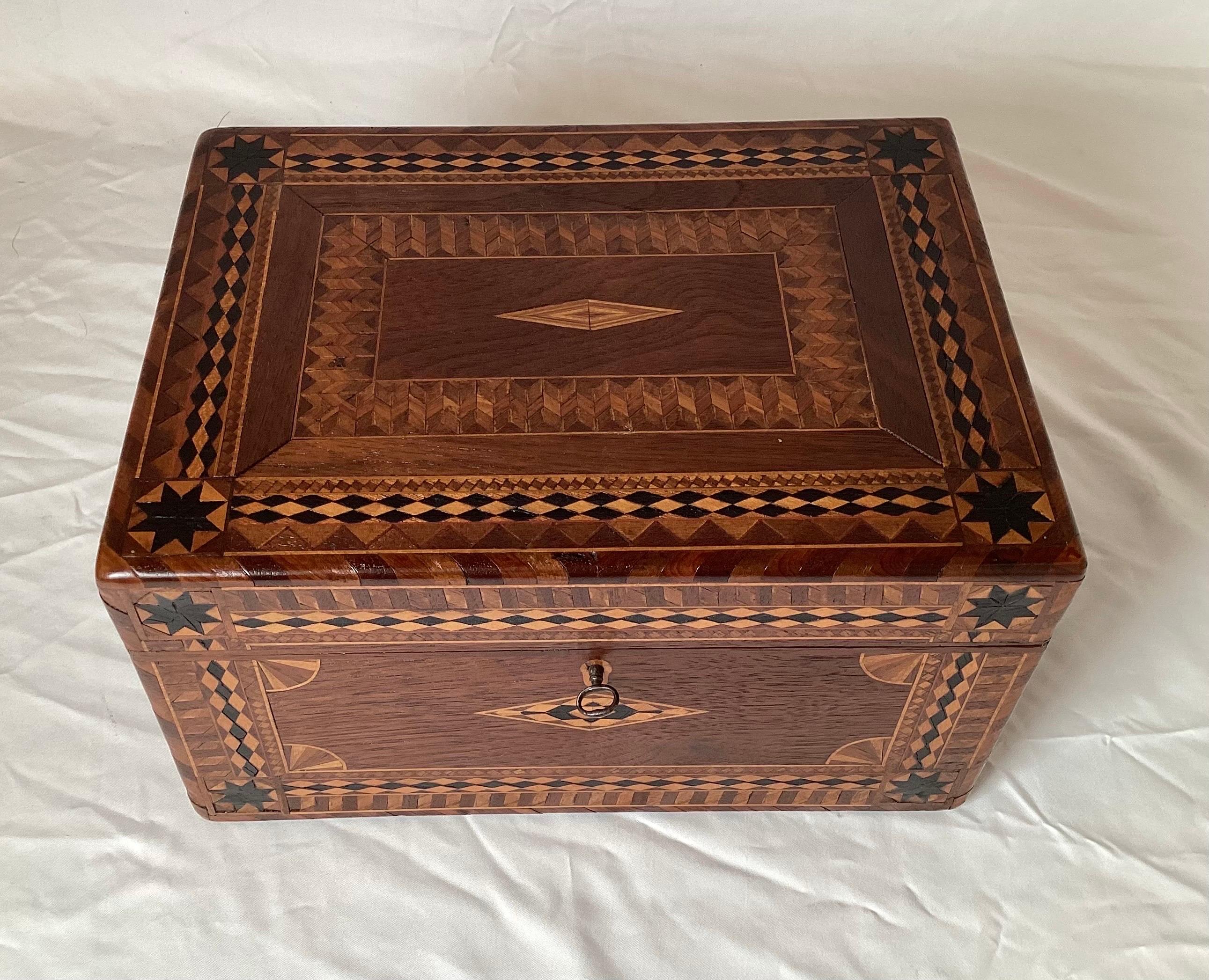 Beautiful intricate inlaid exotic wood jewelry box with tray and oval mirror. Eight sided ebony star decoration with smooth corners. Has working key.