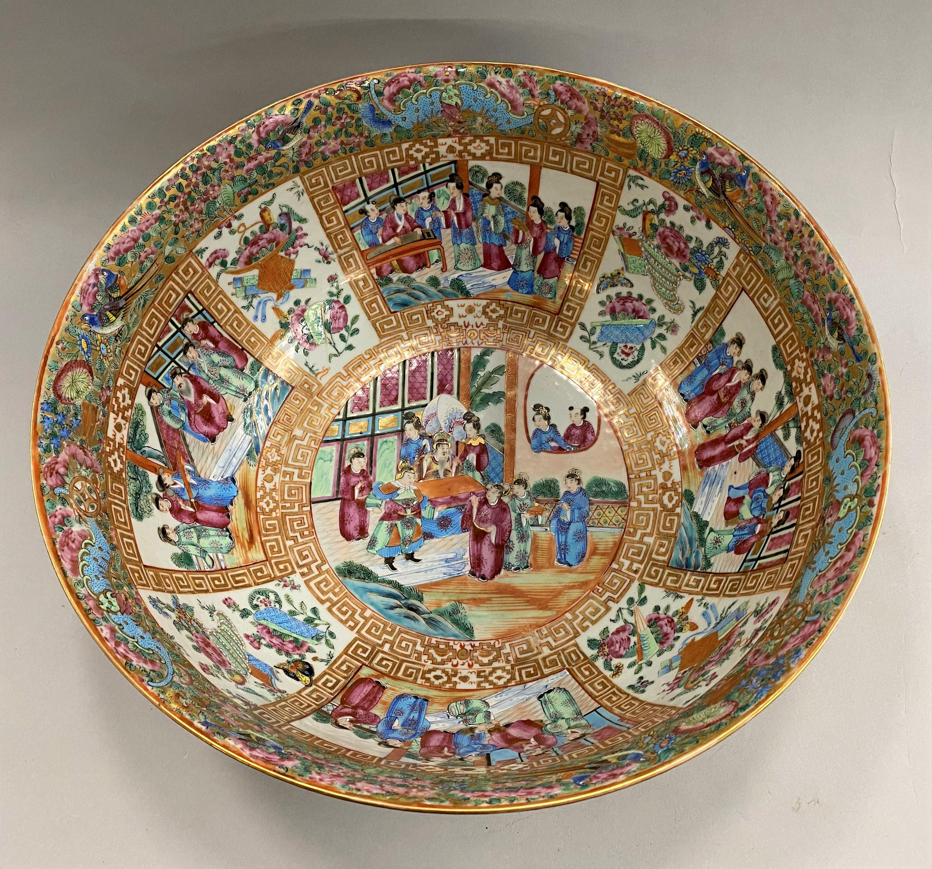 An exceptional Chinese Export Rose Mandarin punch bowl beautifully decorated depicting a central figural scene surrounded by eight interior panels alternating figural and foliate scenes, accented with a detailed bird and butterfly decorated rim, and