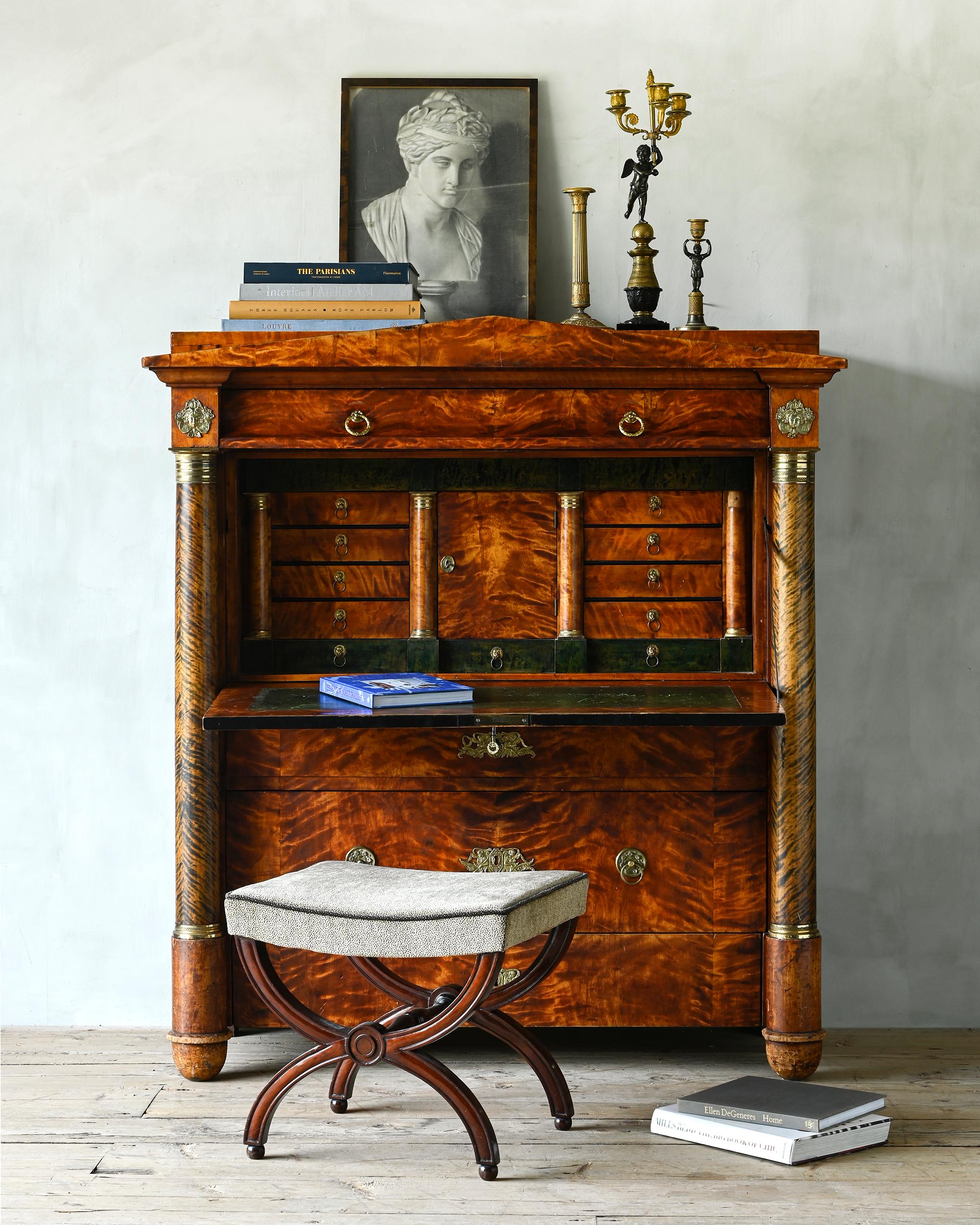 Exceptional architecturally designed 19th century Swedish Empire secretary in flame birch with great subtle patination. Exterior with a folding writing board with leather inlay and four drawers flanked by columns. Fittings of bronze and pressed