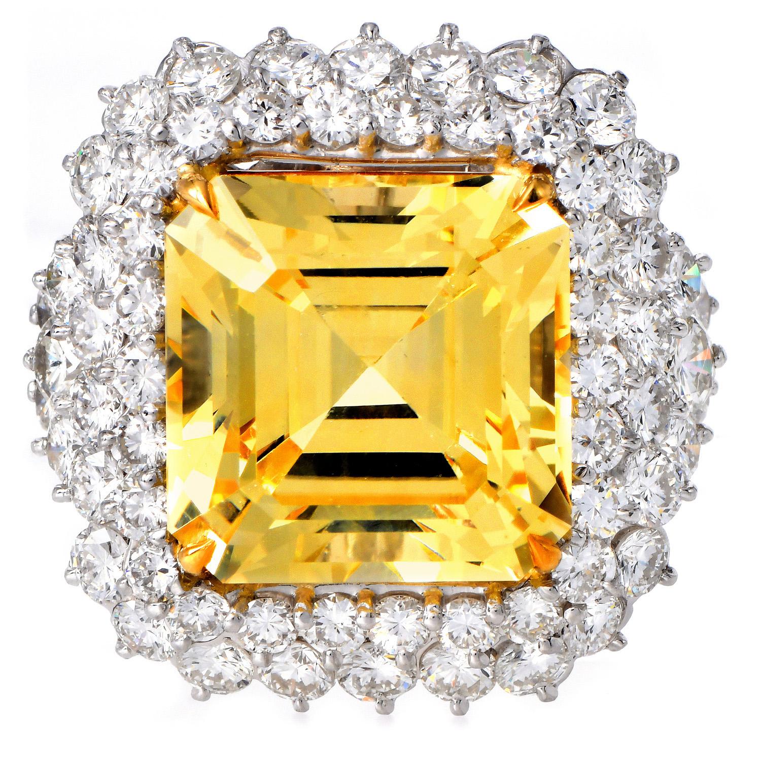 A true statement of luxury and rarity, this cocktail ring features an impressive 20.64-carat octagonal step-cut yellow sapphire, certified by GIA as unheated. Its vibrant golden hue is accentuated by a double halo of sparkling round brilliant