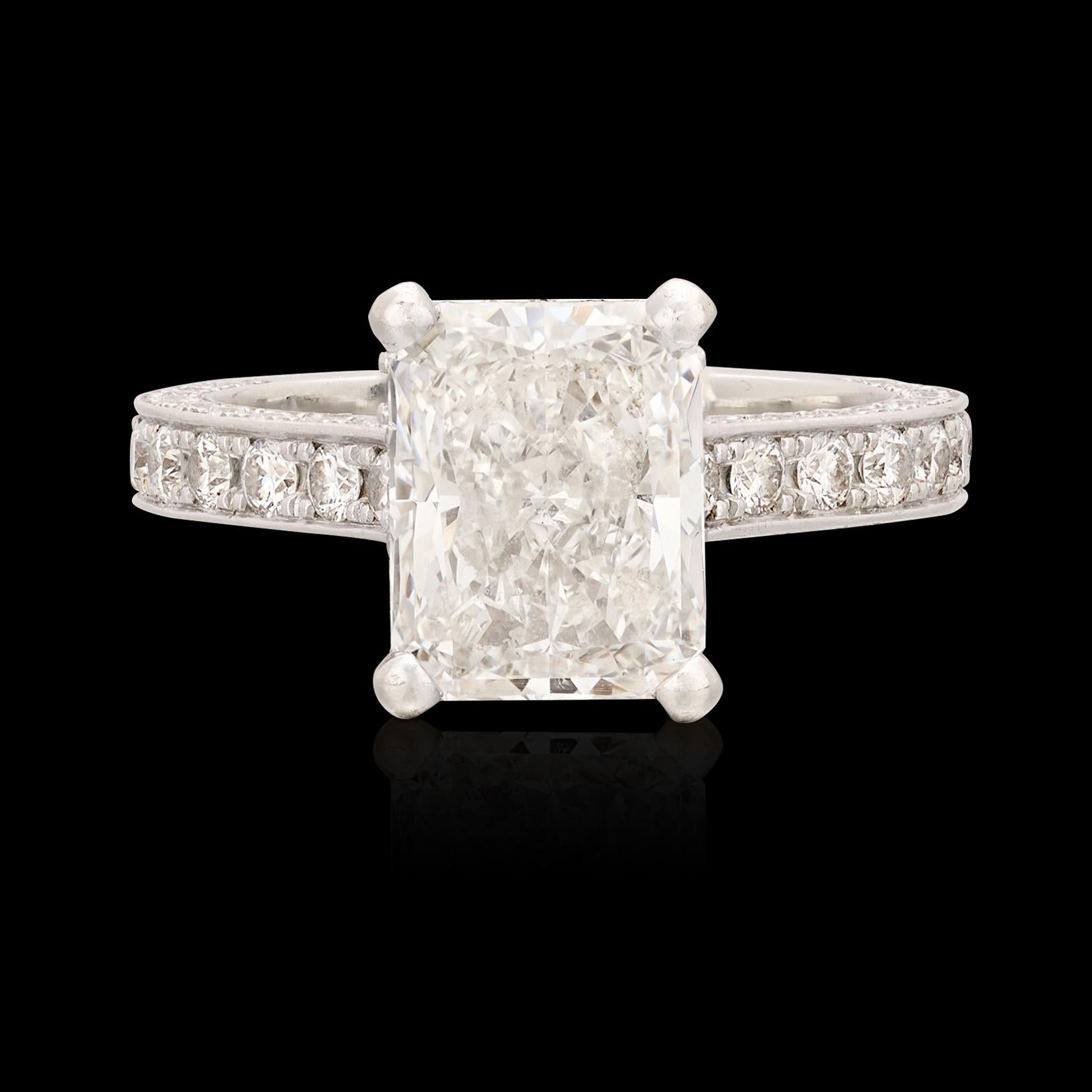 An absolutely gorgeous diamond set in a unique mounting designed for maximum sparkle and brilliance! This 18 karat white gold beauty showcases a stunning 3.01 carat Radiant Cut diamond expertly set with four prongs floating above a halo of fine