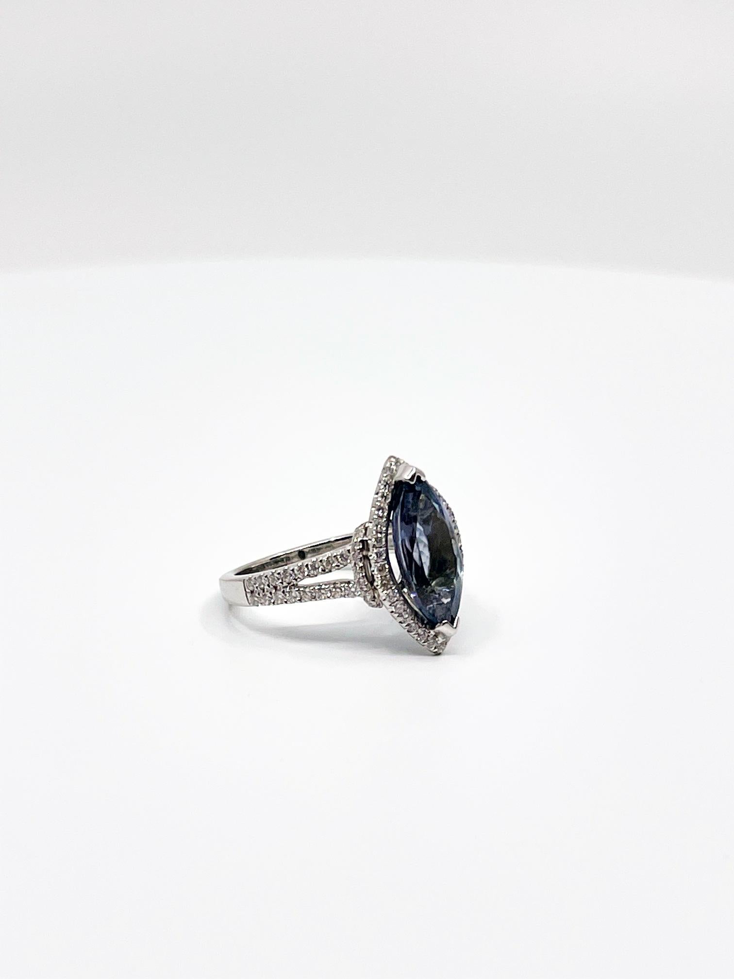 A stunning example of a 3.55ct marquise cut, eye clean tanzanite ring, surrounded by 100 brilliant cut diamonds (G/SI) set in a halo and along the band, in 18ct white gold. 