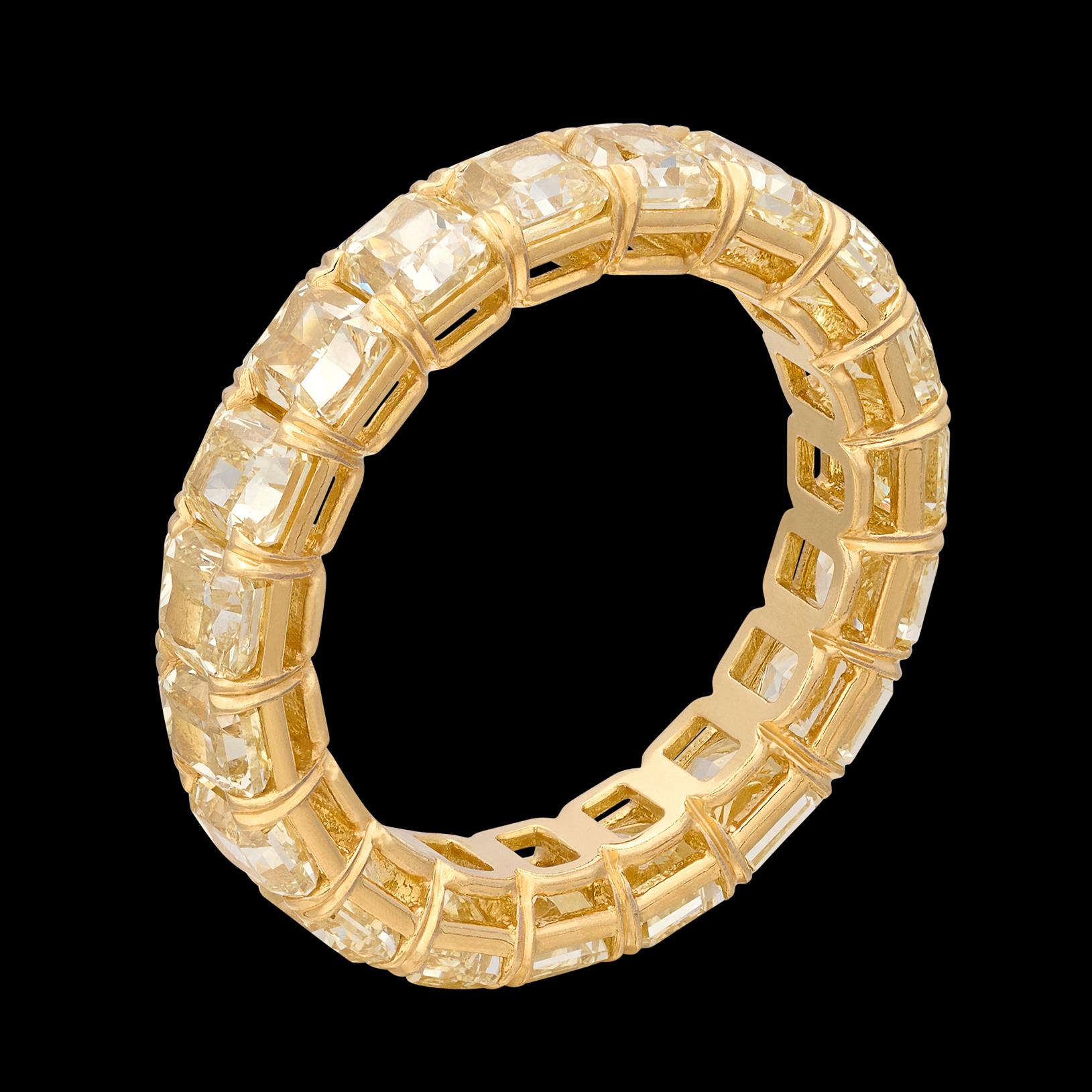 There are eternity bands, and then there's THIS! This extraordinary 18 karat yellow gold eternity band features 19 perfectly matched yellow radiant cut diamonds, expertly set with shared prongs to make up a truly fantastic piece of jewelry. The