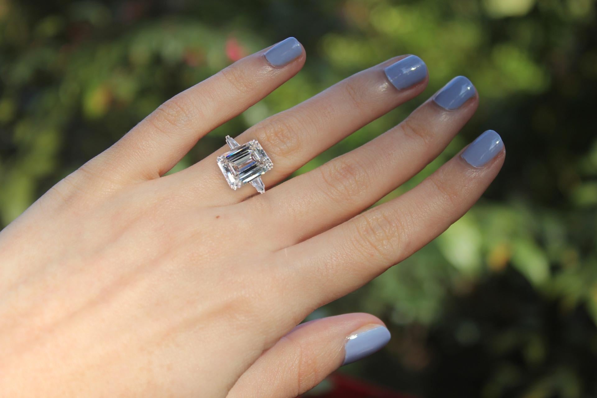 An exceptional emerald cut diamond ring the main stone weights 5 carats  is a very white G color clarity is vs2 100% eye clean stone and has excellent polish and cut with none fluorescence.

This diamond has the perfect proportion so it actually
