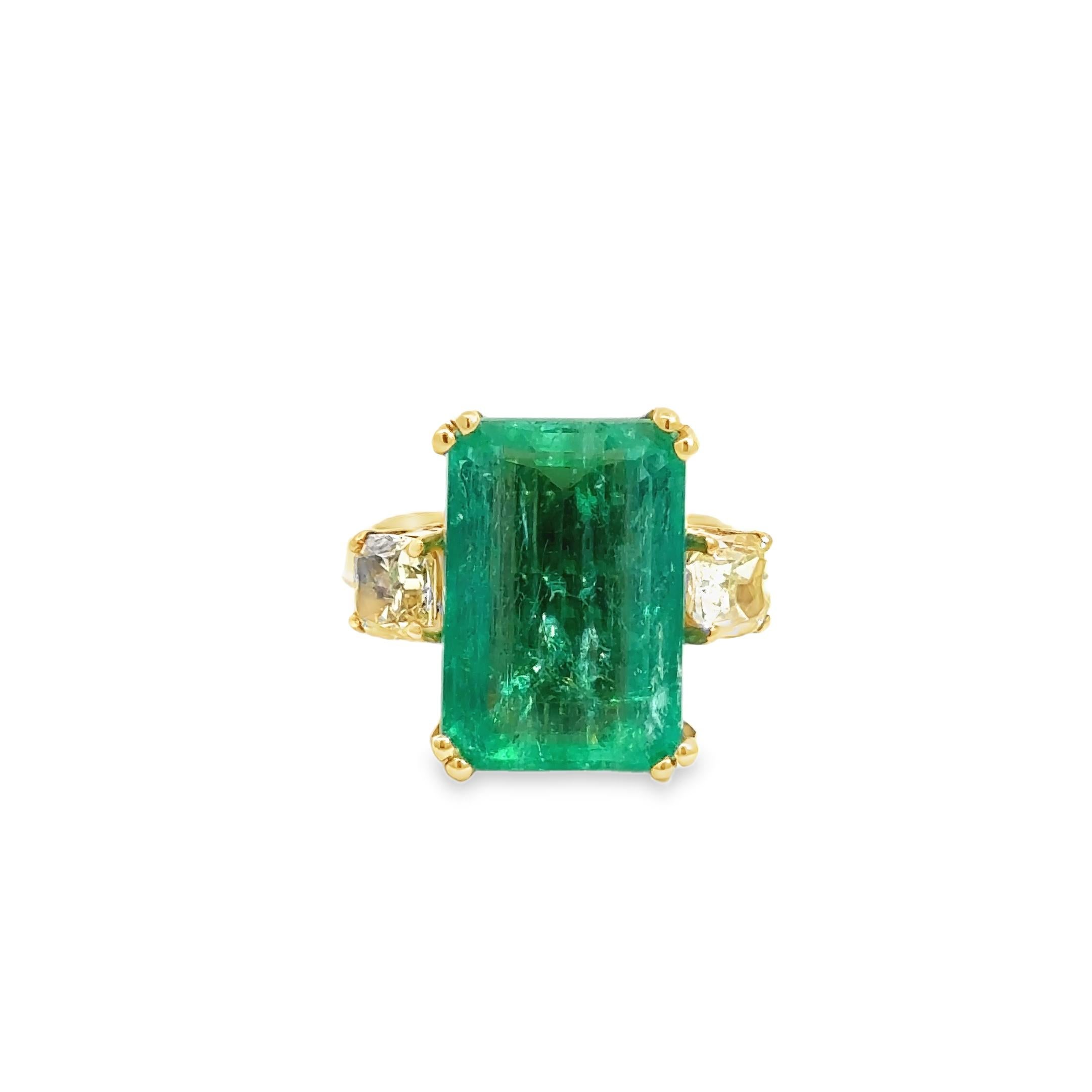 A striking blend of vivid color and timeless design, this cocktail ring showcases a mesmerizing 7.90-carat Columbian emerald-cut emerald at its center—prized for its rich green saturation and natural internal character. Set in 14k yellow gold, the