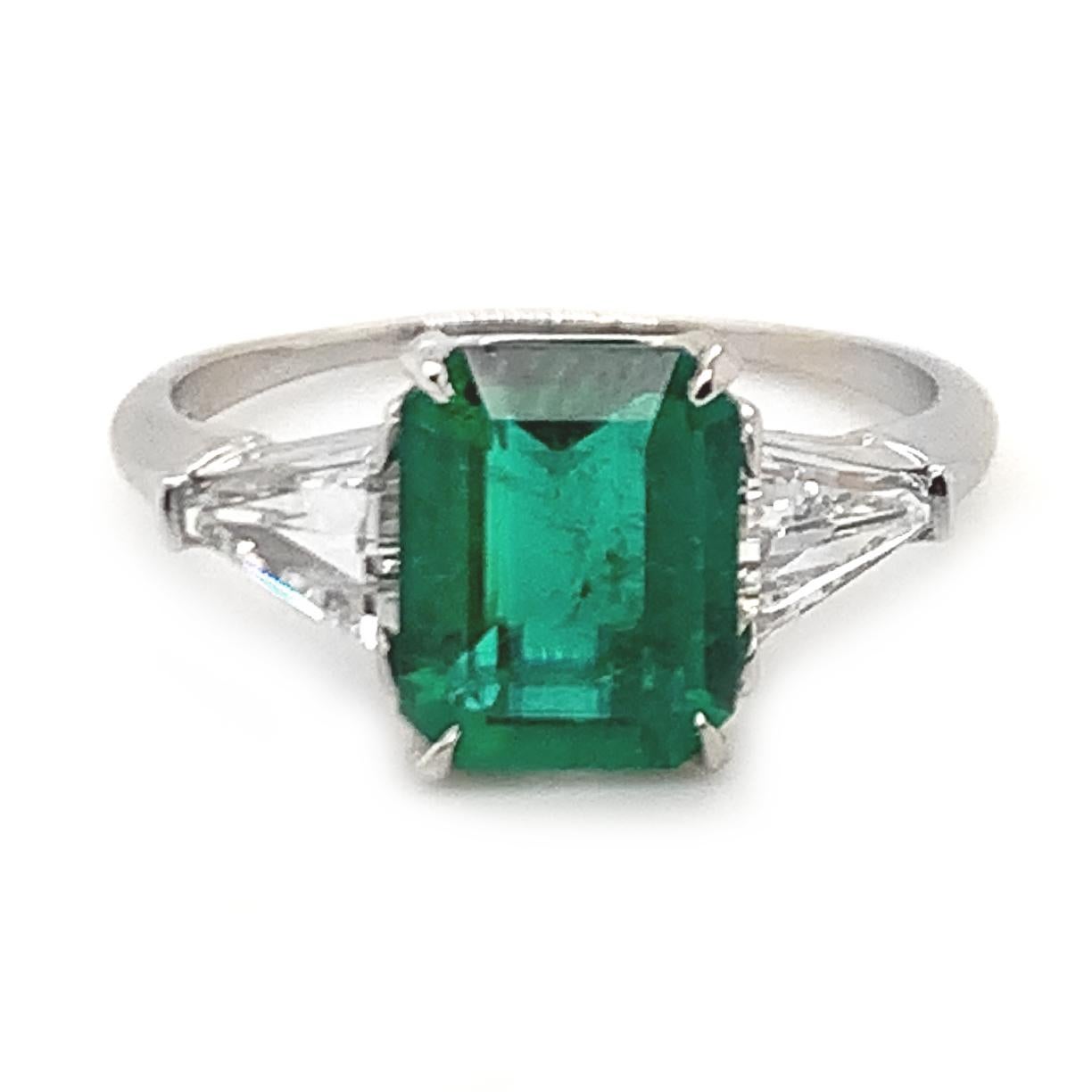 Breathtaking handmade emerald and diamond  engagement ring.  Set in platinum.  Centered with an AGL (American Gemological Laboratories) certified natural emerald-cut emerald that weighs 1.60 carats. This magnificent deep saturated color is natural