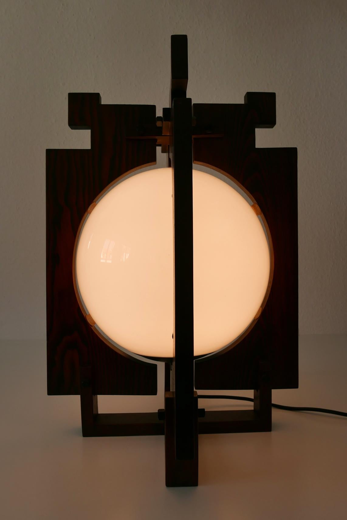 Extremely rare and large Amsterdam School Art Deco light which can be used as pendant, table or floor lamp.The previous owner seems to have used it as table or floor lamp. With interrupter on the cord.

Executed in wood and opaline glass. It needs
