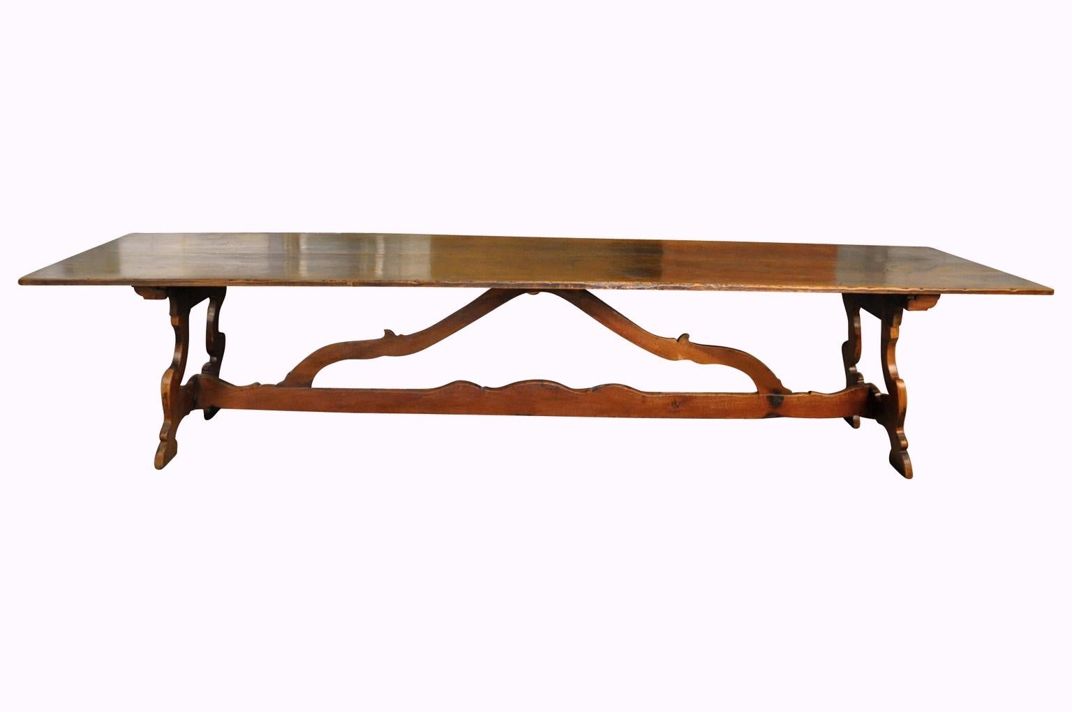 An exceptional and grand scale 18th century Northern Italian trestle table - dining table. Superbly constructed from stunning walnut with classical lyre legs and wonderfully sculpted stretchers. Sensational patina and graining. A truly exquisite