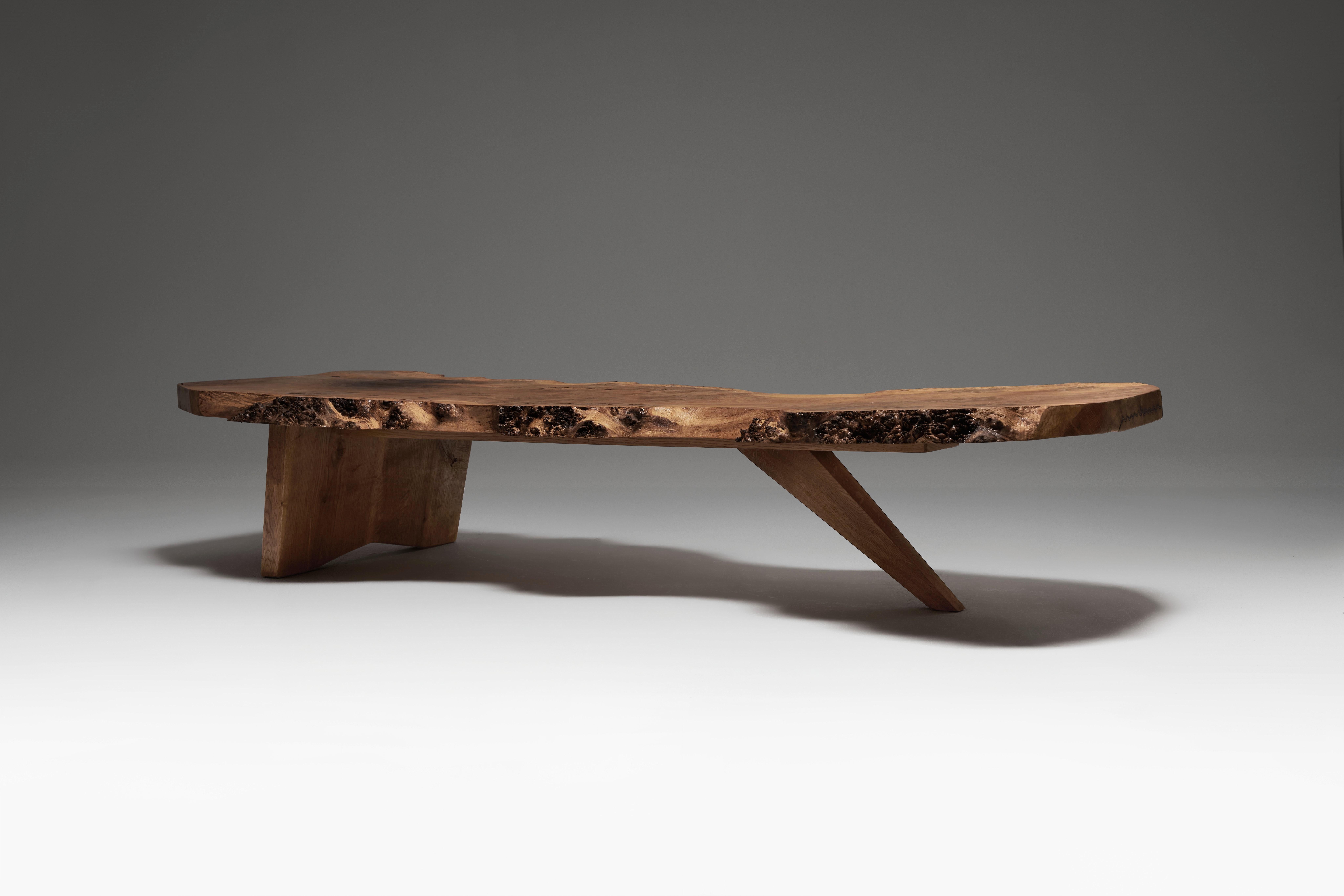 This exceptional free-form coffee table hails from England in the 1970s.
 Crafted from English oak burl. 
The sublime English oak burl slab is distinguished by its dramatic, undulating free-form edges and textured burls, which imbue the table with