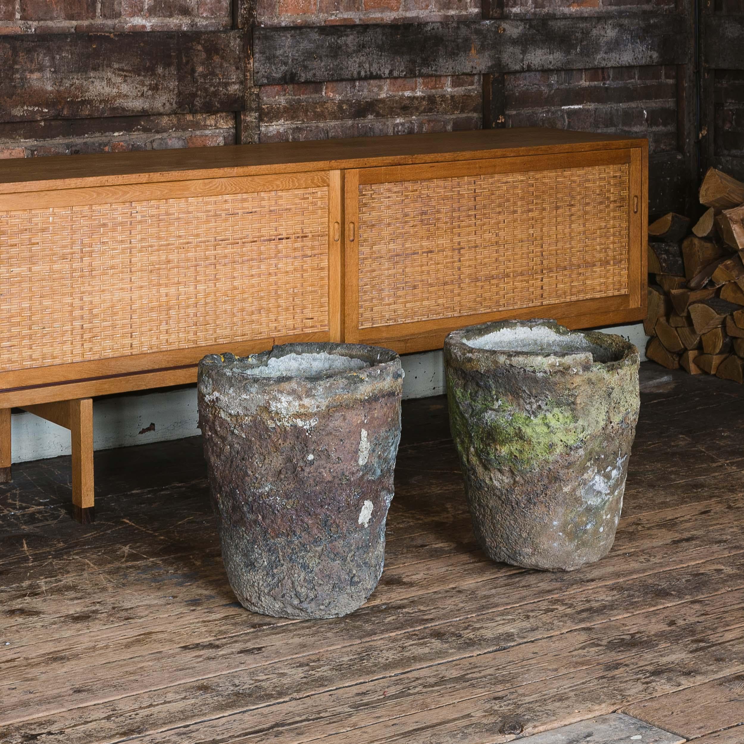 Exceptional pair of foundry crucibles, mid-twentieth century, well patinated throughout, previously drilled for used as planters. A remarkable duo with a fabulously coloured and textured surface.